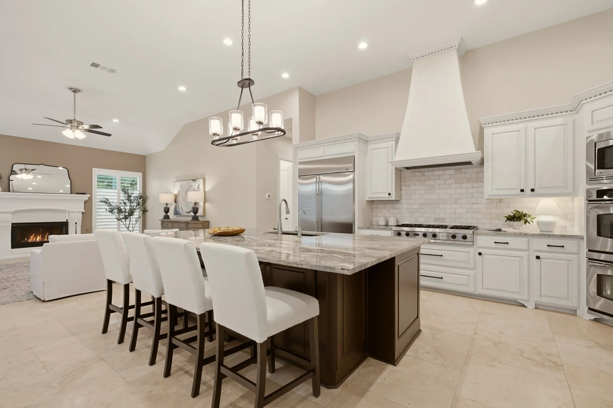 A beautifully redesigned luxury kitchen boasts many upgrades. Among them:  high-end Fusion Quartzite countertops + on the massive island. Handy pull-out drawers under the island too for seasonal serving pieces.