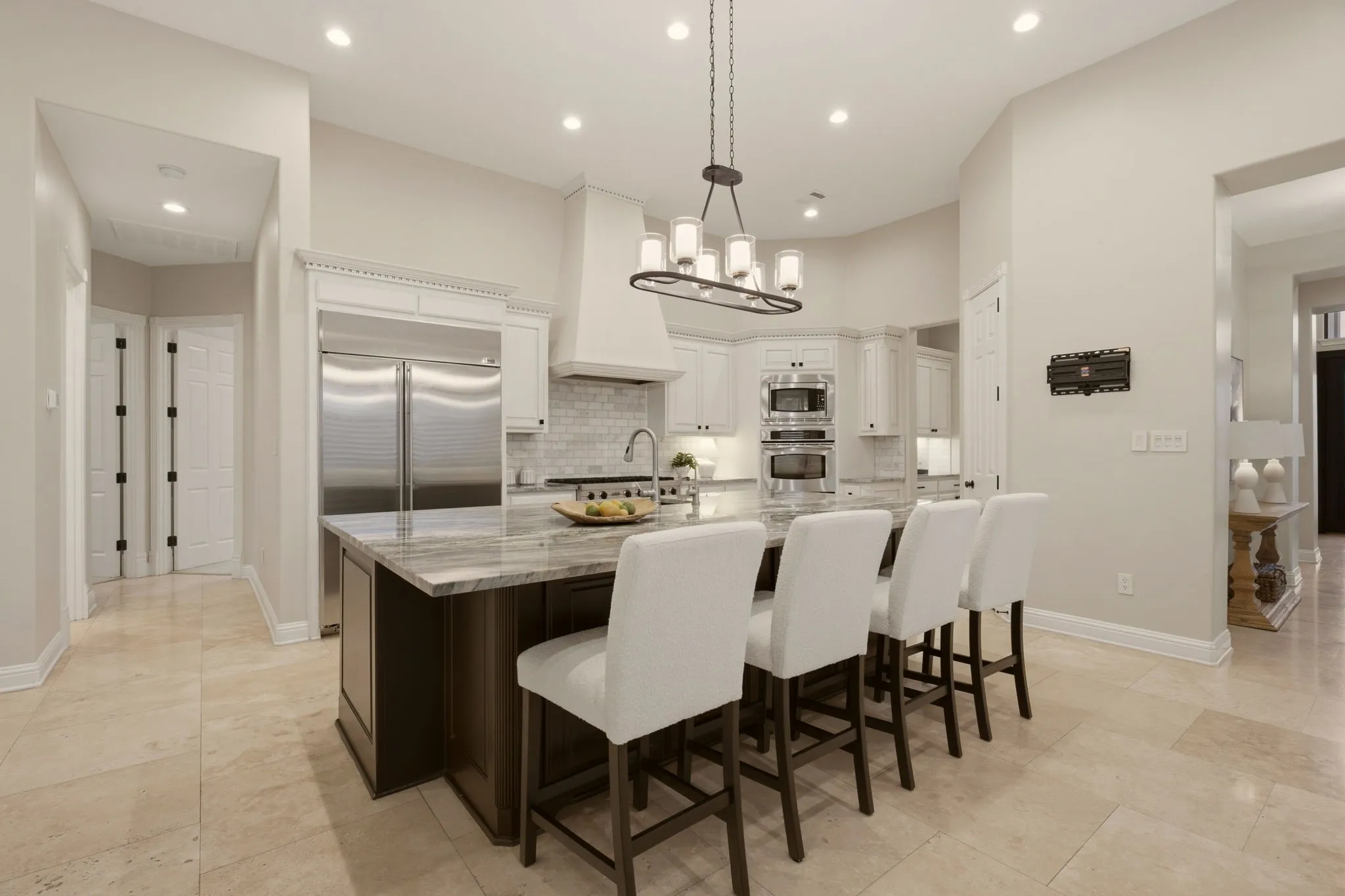 This impressive kitchen is a true centerpiece of the home, featuring decorator lighting, hardware + a massive center island that offers ample room for meal prep, casual dining & gathering of friends.