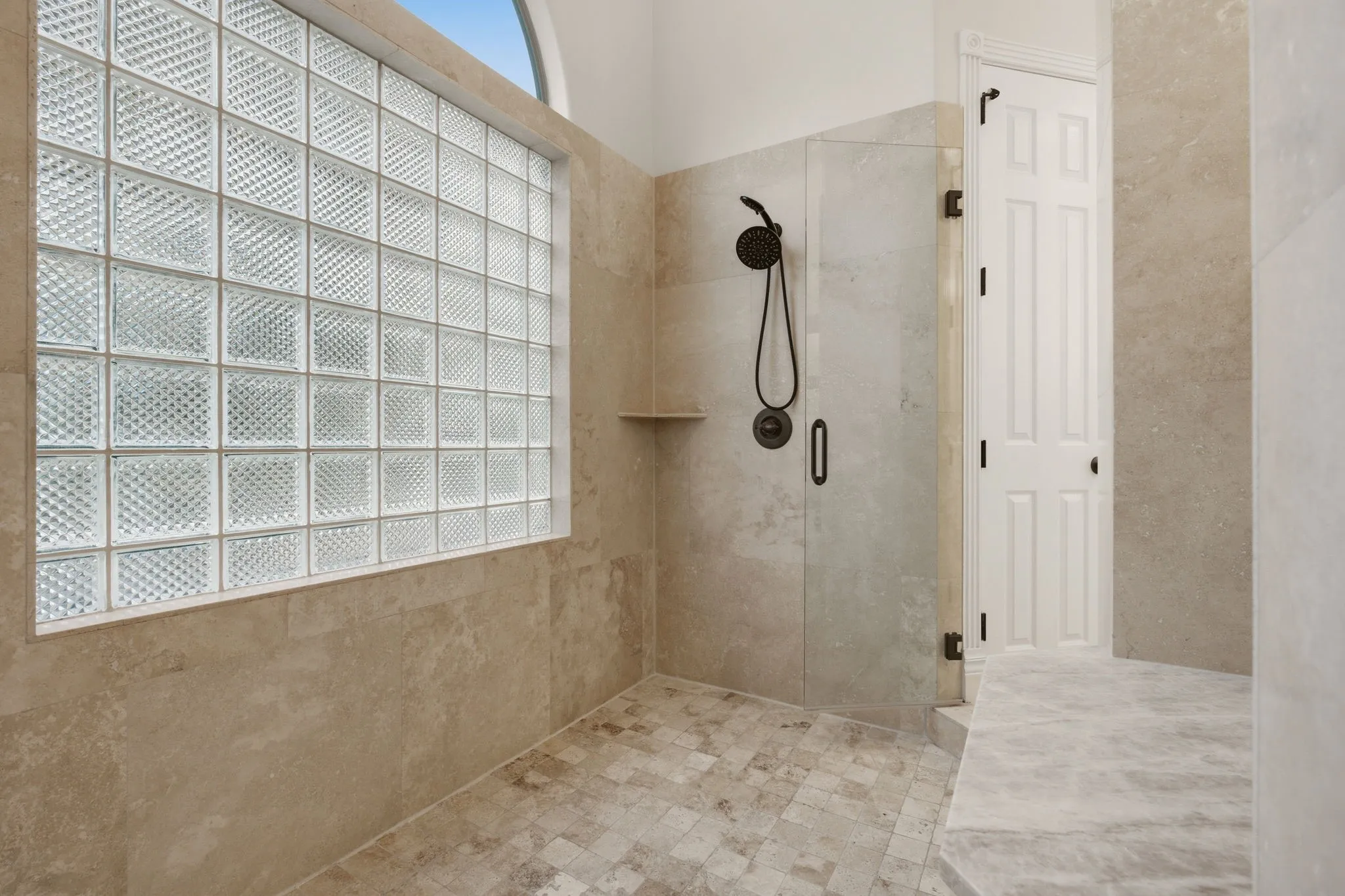 Enhancing the spa experience, the massive walk-in shower has frameless doors on each entry side.