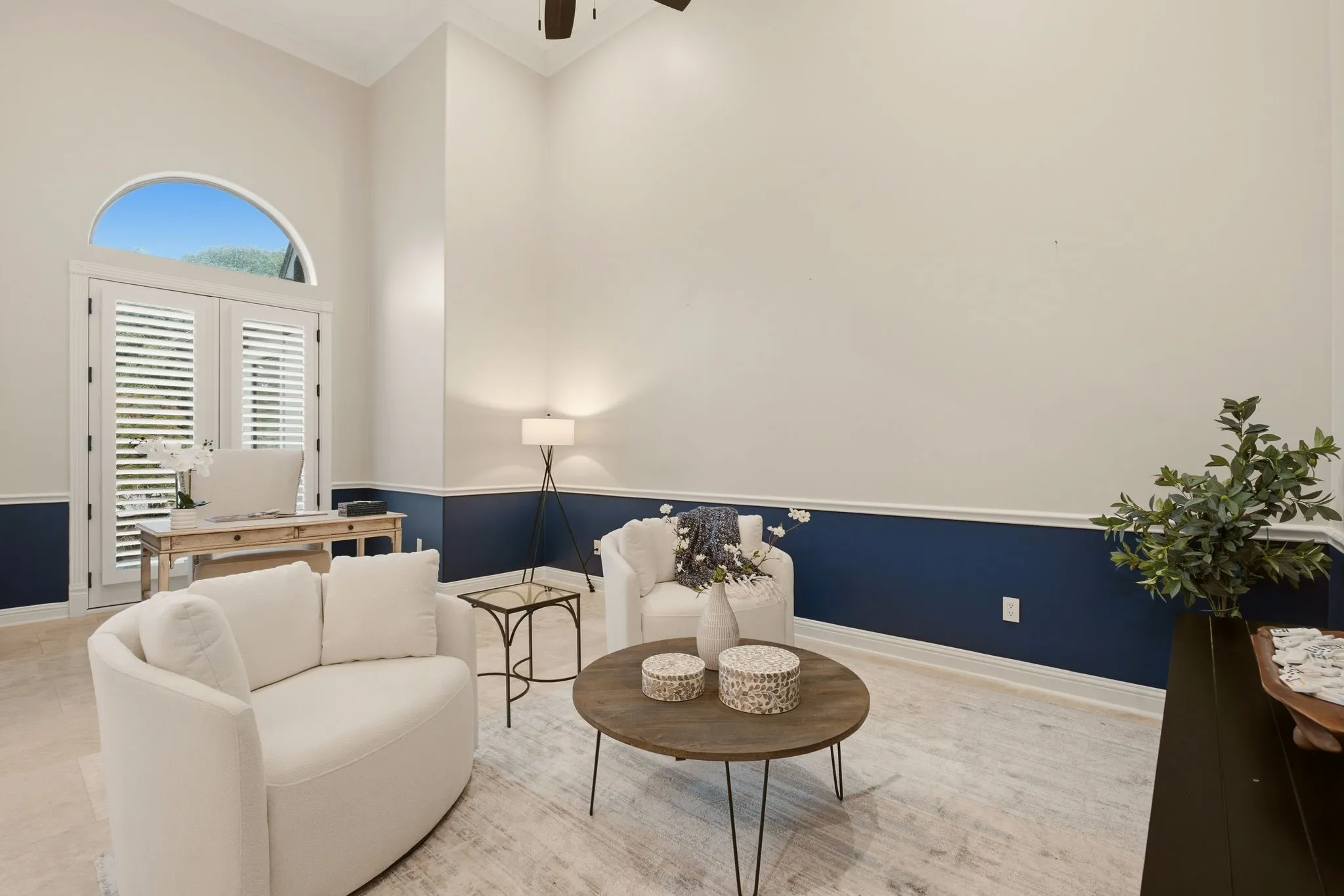 Dramatic high ceilings, fresh paint & another set of French doors .... this living room offers a clean, modern aesthetic for multiple uses. Consider using this space as a study &/or a media room.