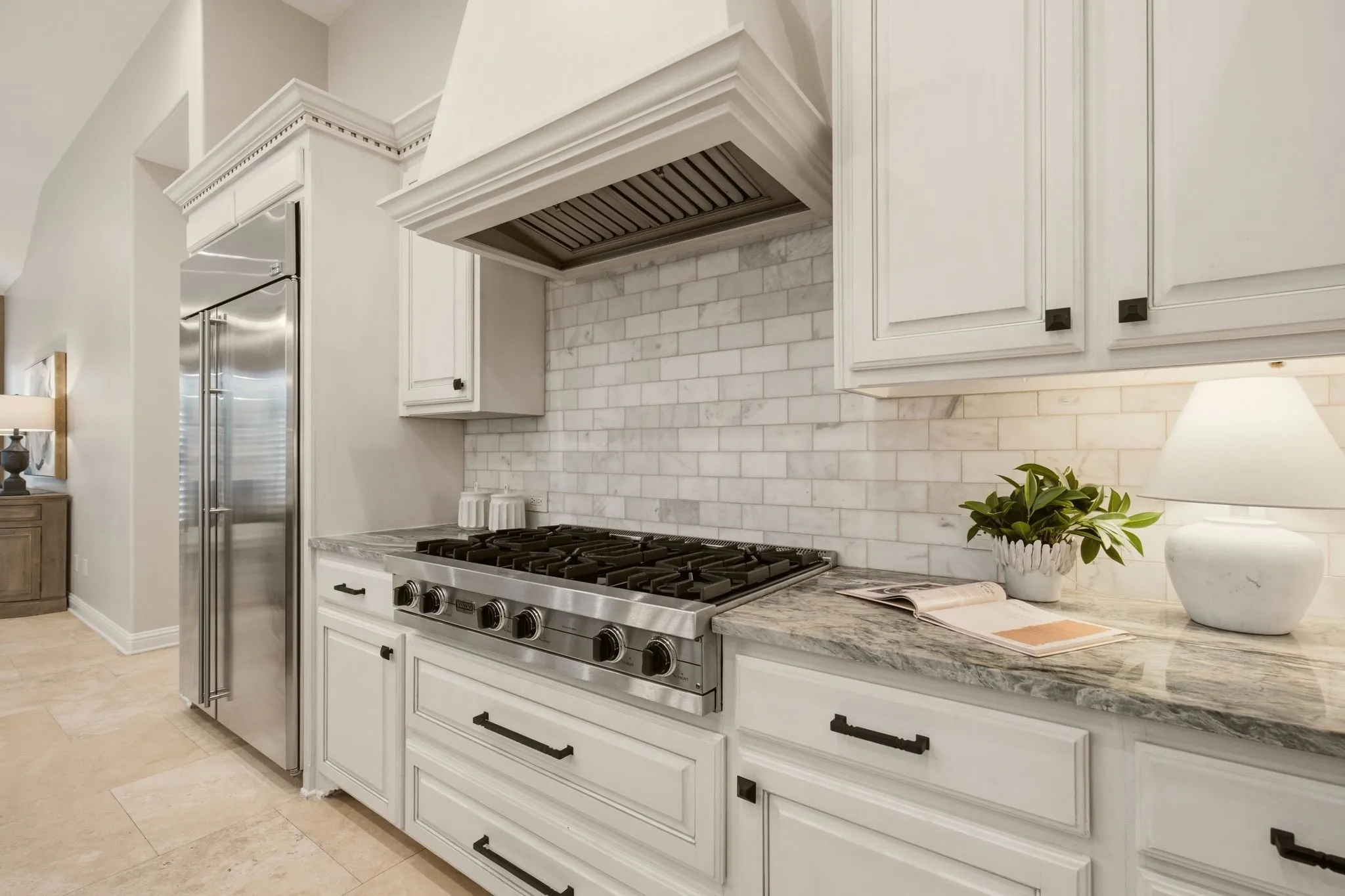A full compliment of stainless appliances include: a built-in refrigerator, commercial grade 6-burner Viking gas cooktop, double ovens, a microwave.