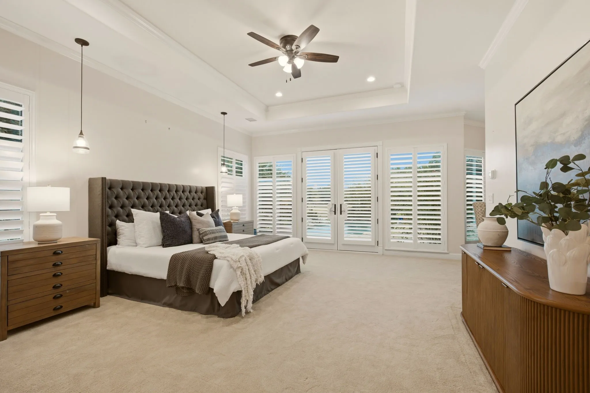 The primary bedroom's spacious dimensions encompass an adjacent sitting area.