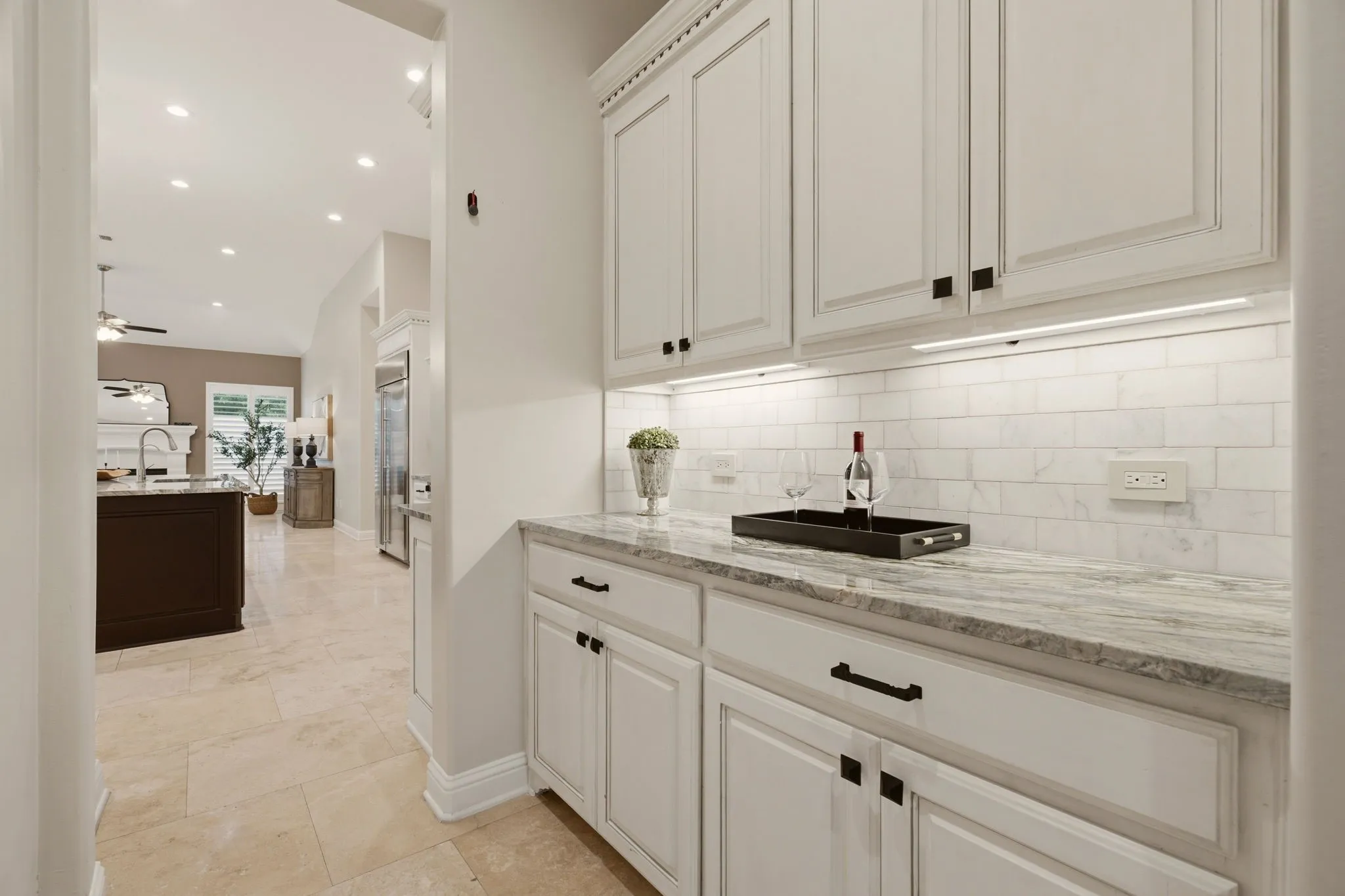 Located between the kitchen & formal dining room is this handy butler pantry. Take note of the subway tile backsplash shown here & in the kitchen.