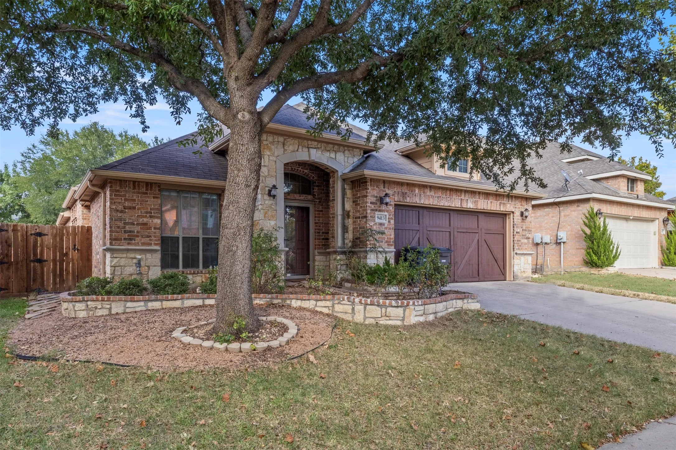 Brick and stone exterior with an arched entry