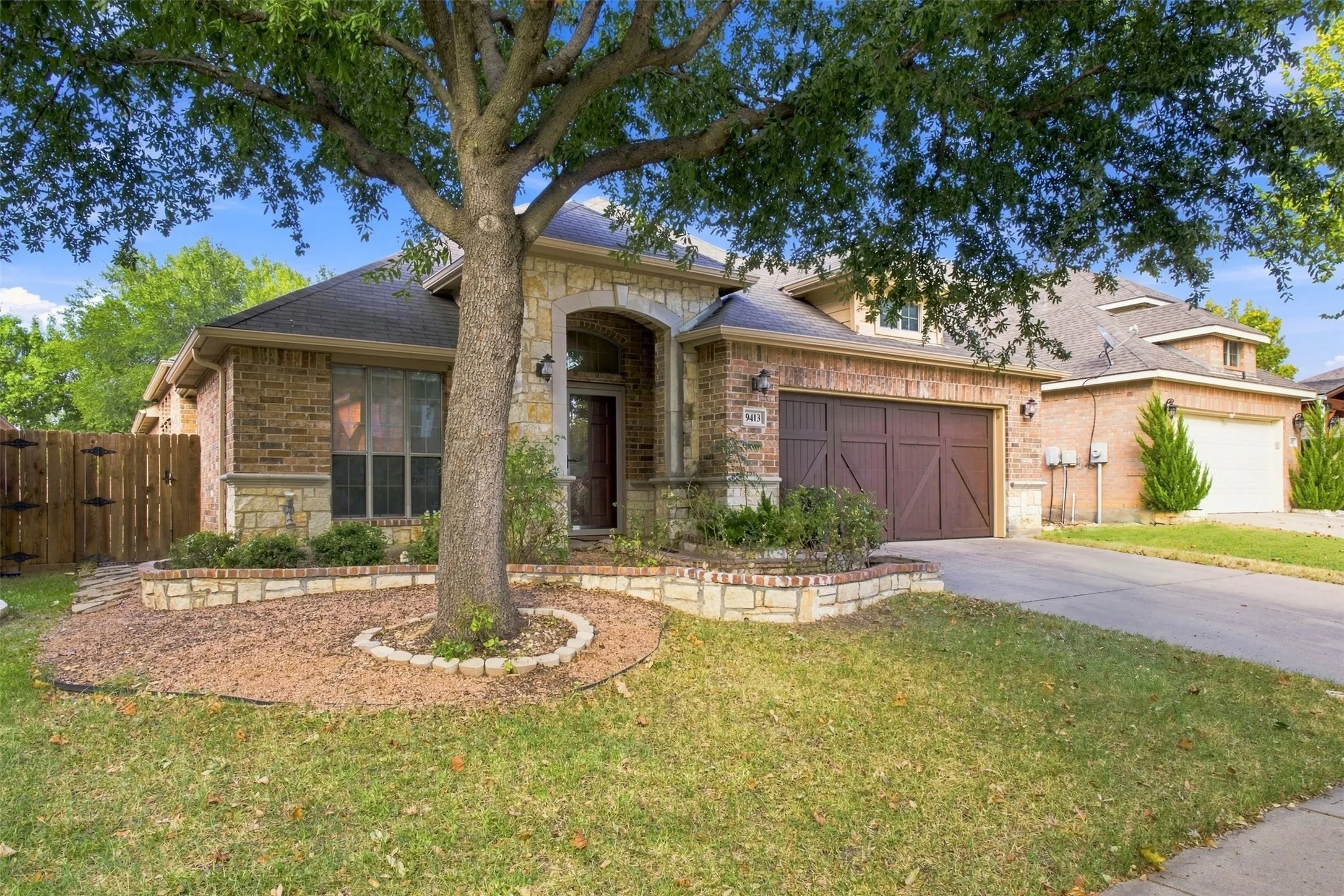 Brick and stone exterior with an arched entry