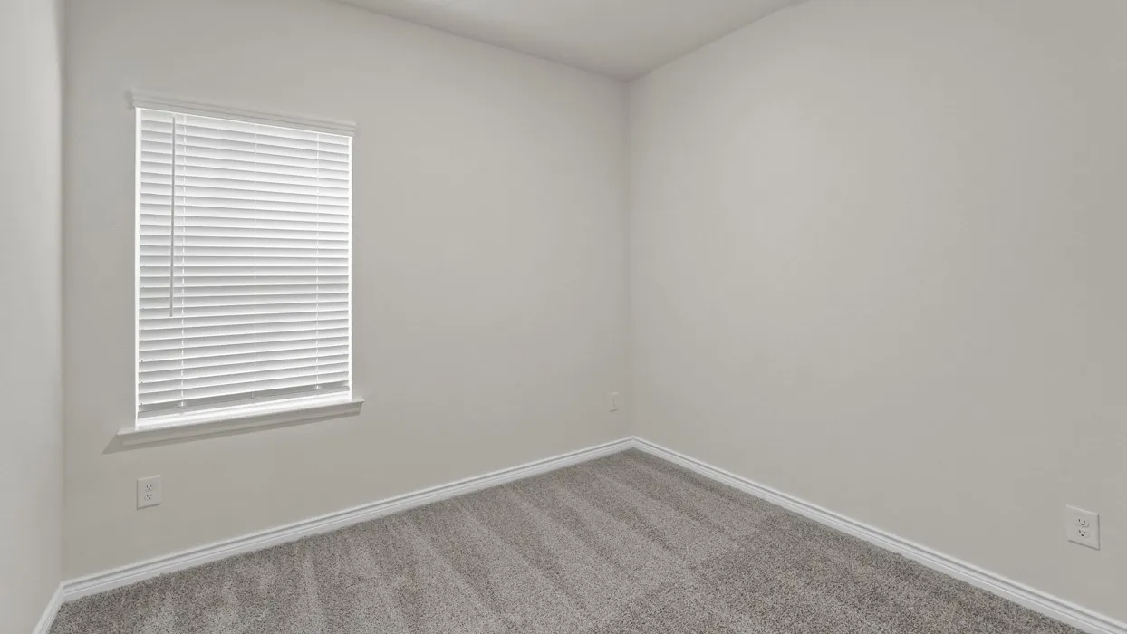 Neutral-toned interior room featuring light gray walls, plush gray carpeting, and white trim
