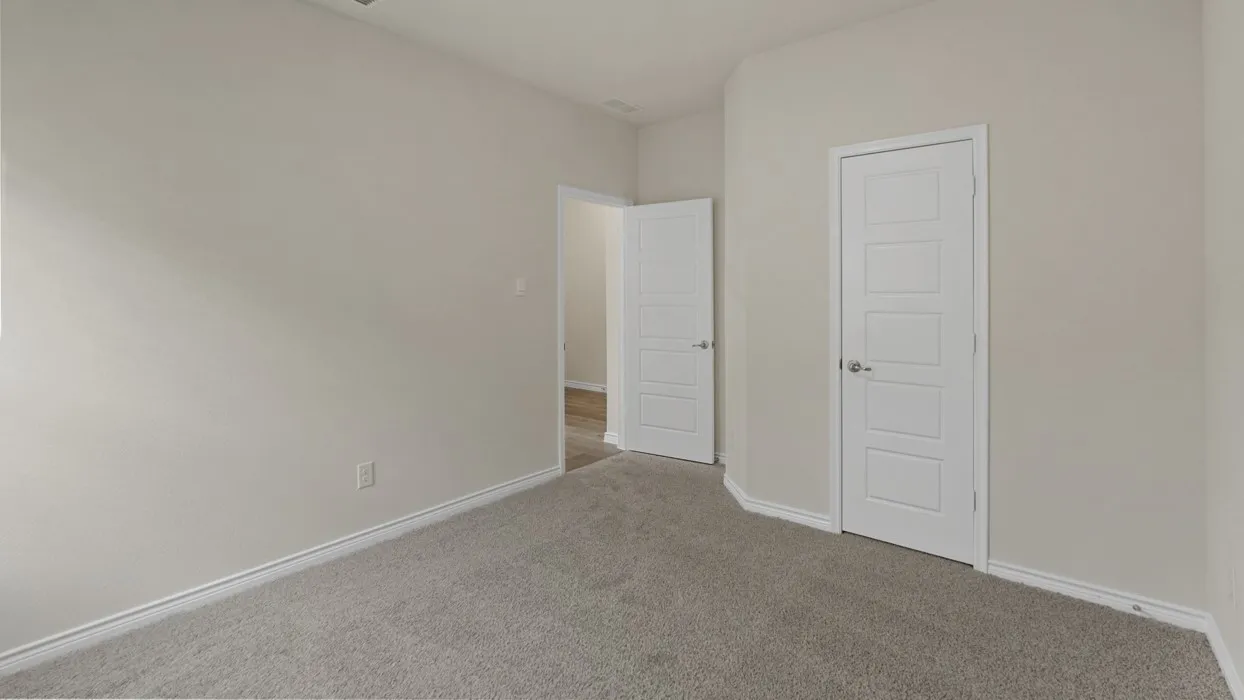 Neutral-toned walls and grey carpeting define this interior space