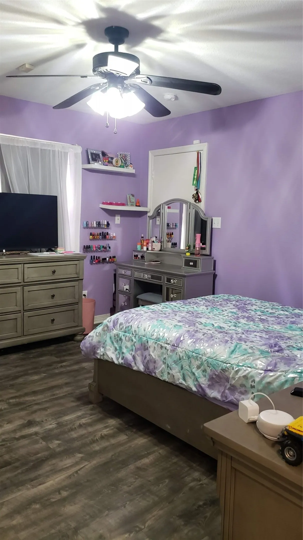 Wood-finish flooring with a ceiling fan light fixture