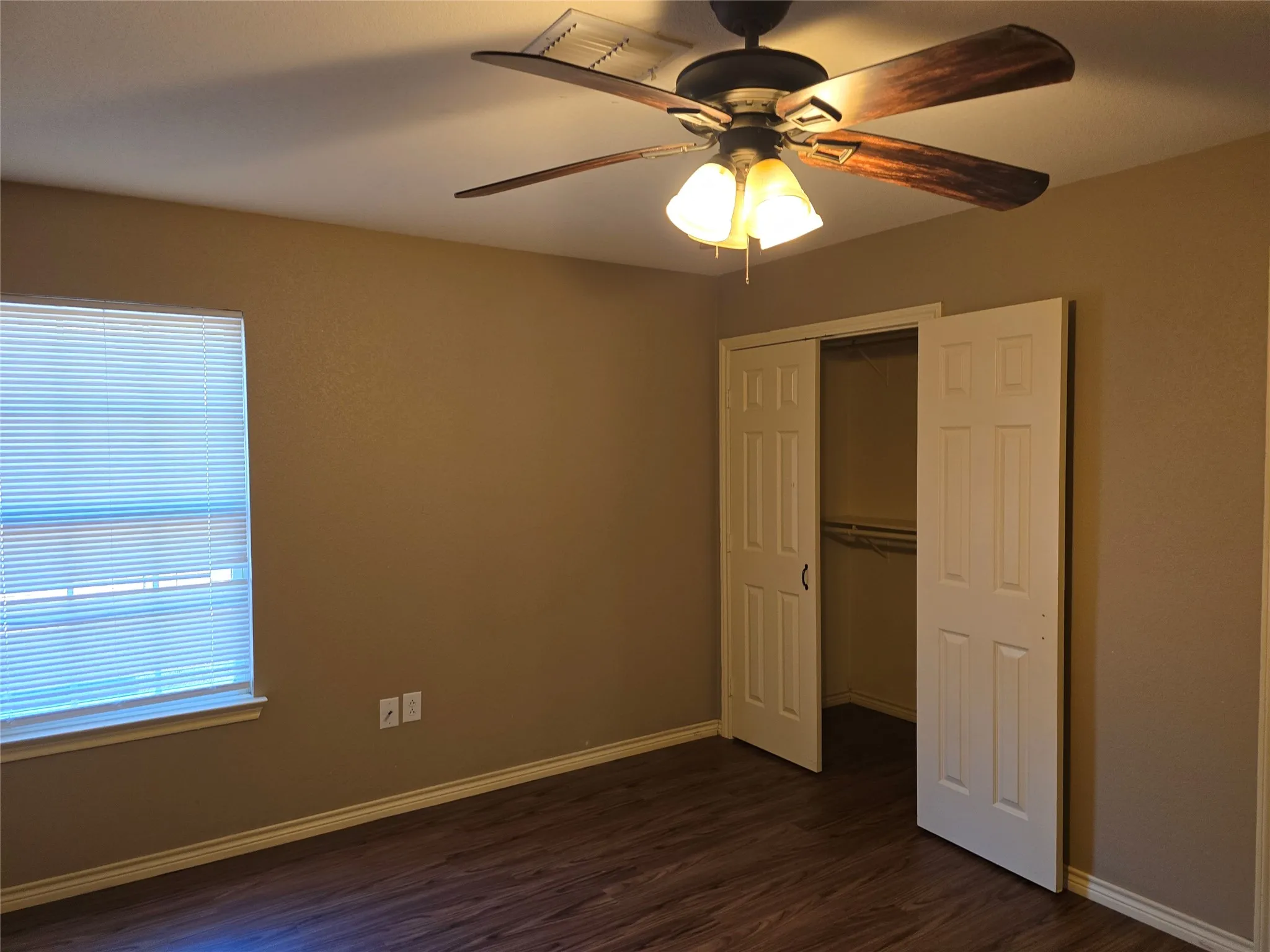 Wood-finish flooring with a ceiling fan light fixture