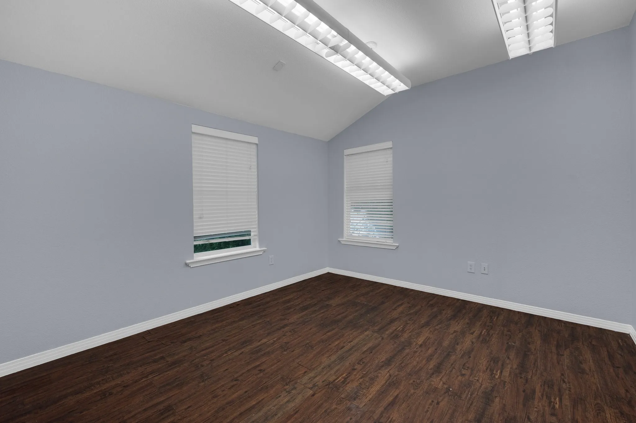 Vaulted ceiling with linear fluorescent lighting fixtures