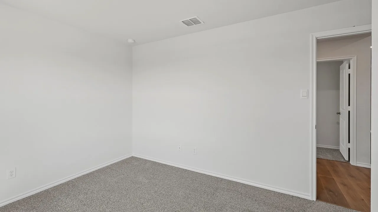 Carpeted flooring, white painted walls, and a recessed ceiling light