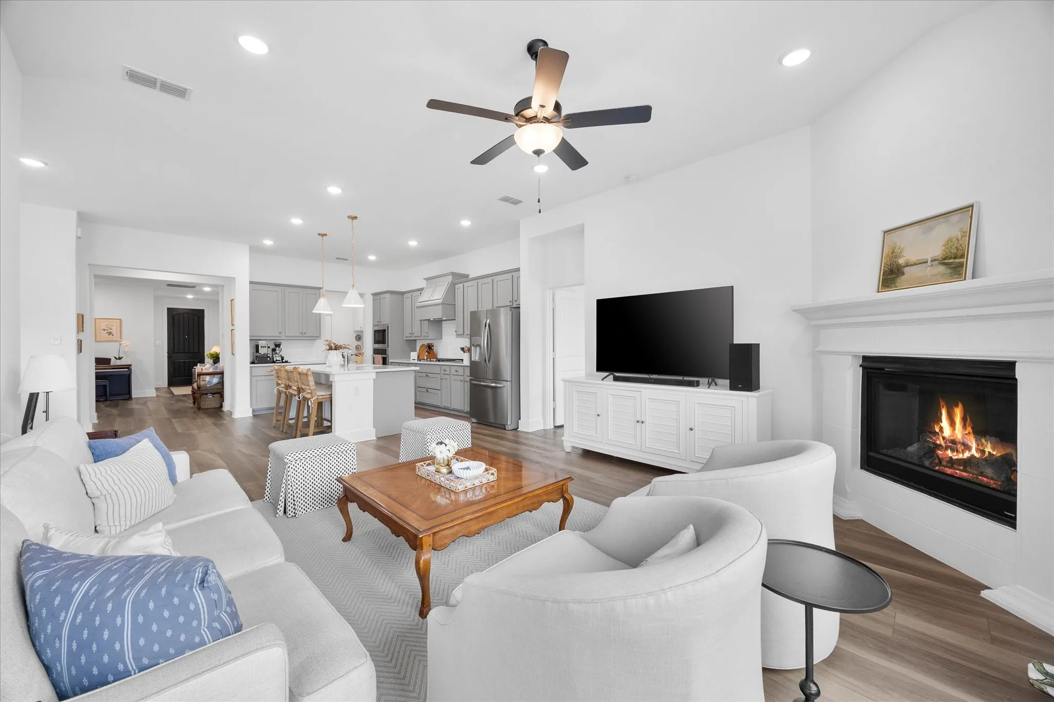 Open concept living with views of kitchen and entry