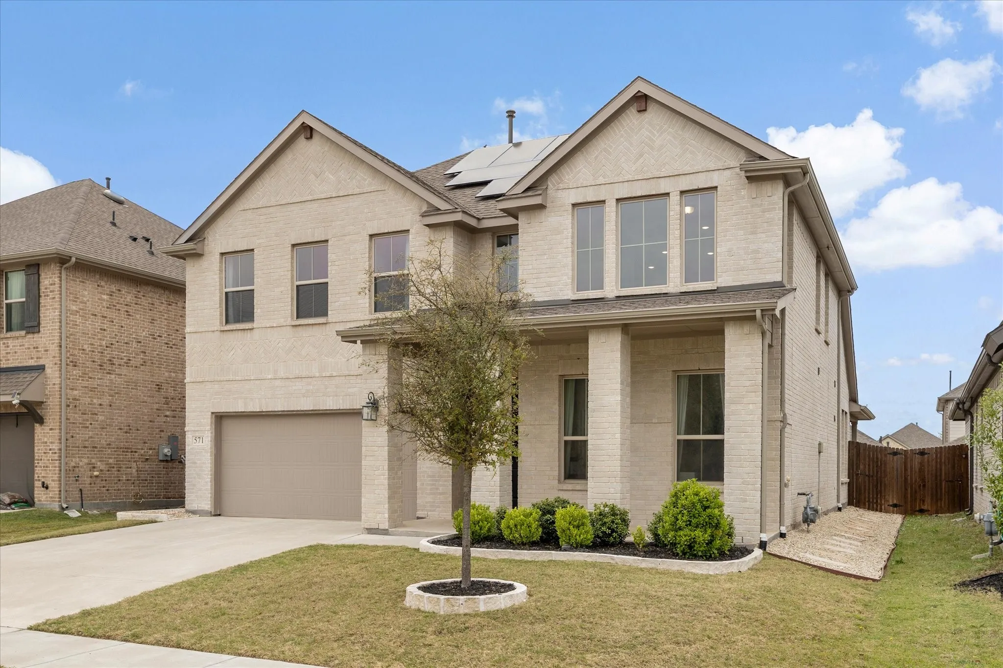 Well landscaped exterior including stone flower beds and rock filled pathways