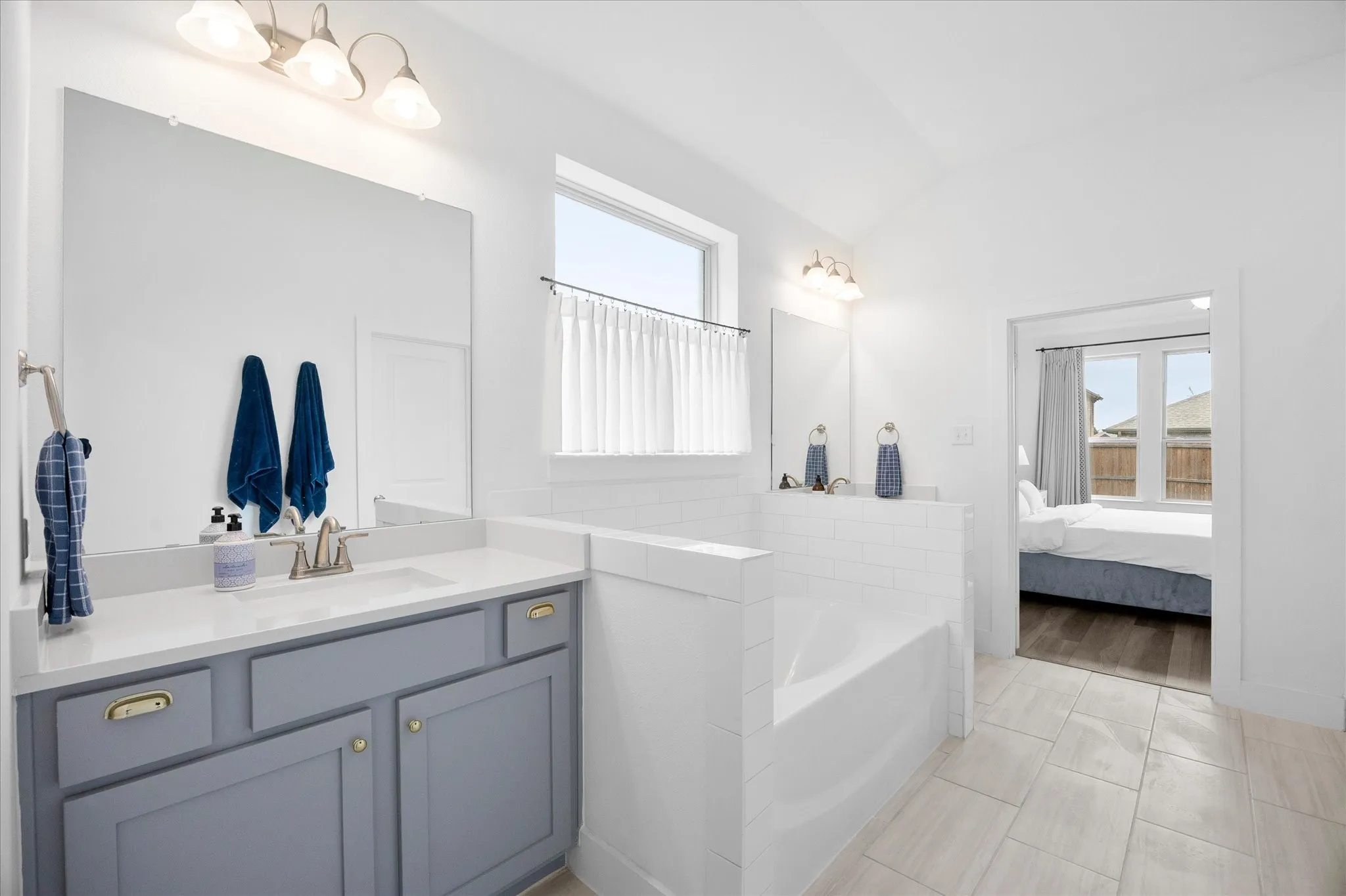Soaking tub and separate vanities in the primary bathroom