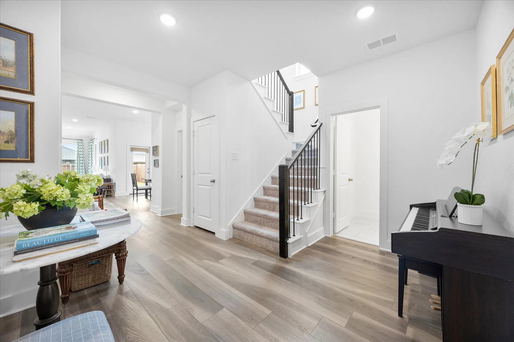 End of stairs landing area with half bath entry
