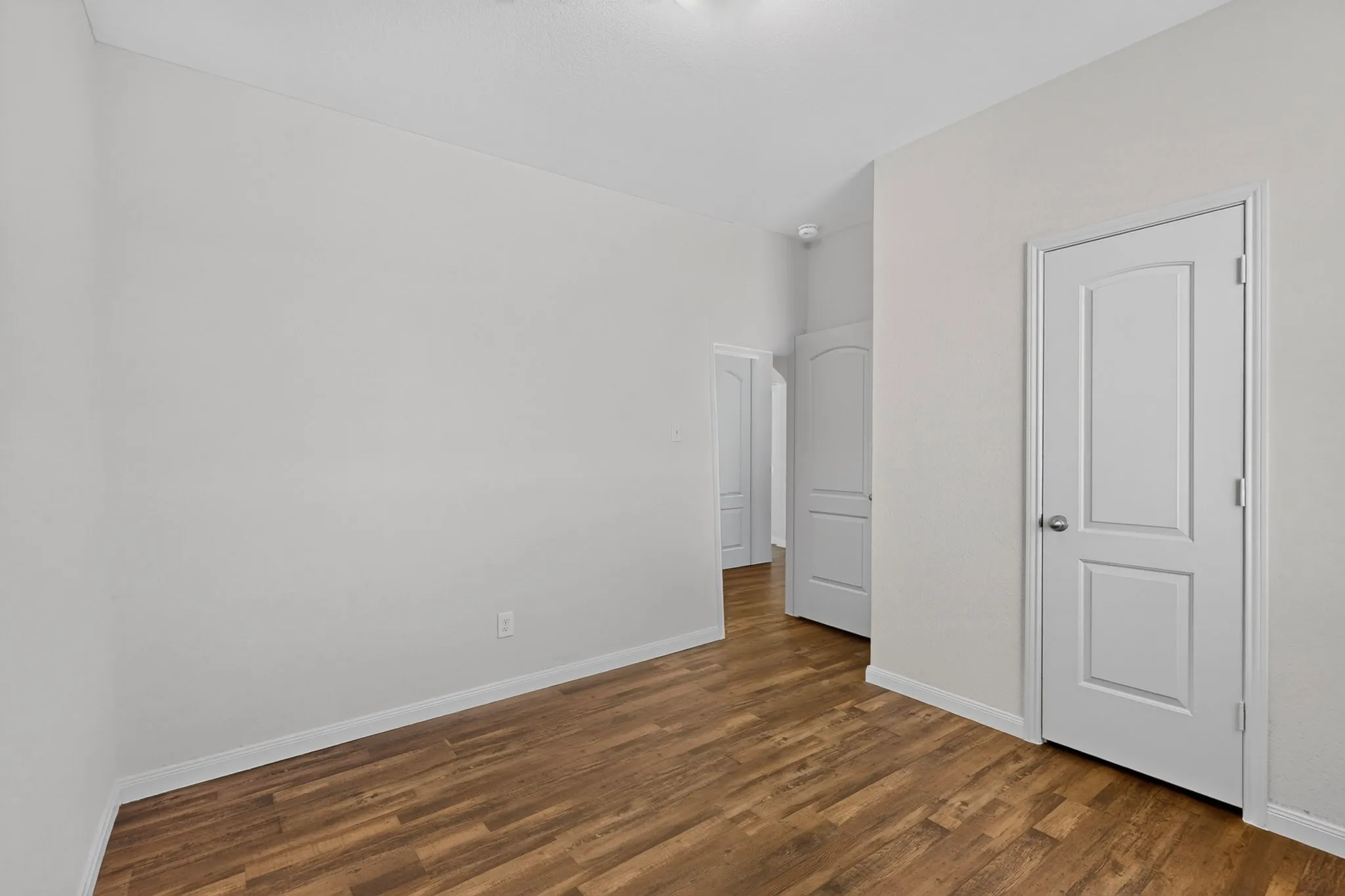 Neutral wall color with wood-finish flooring