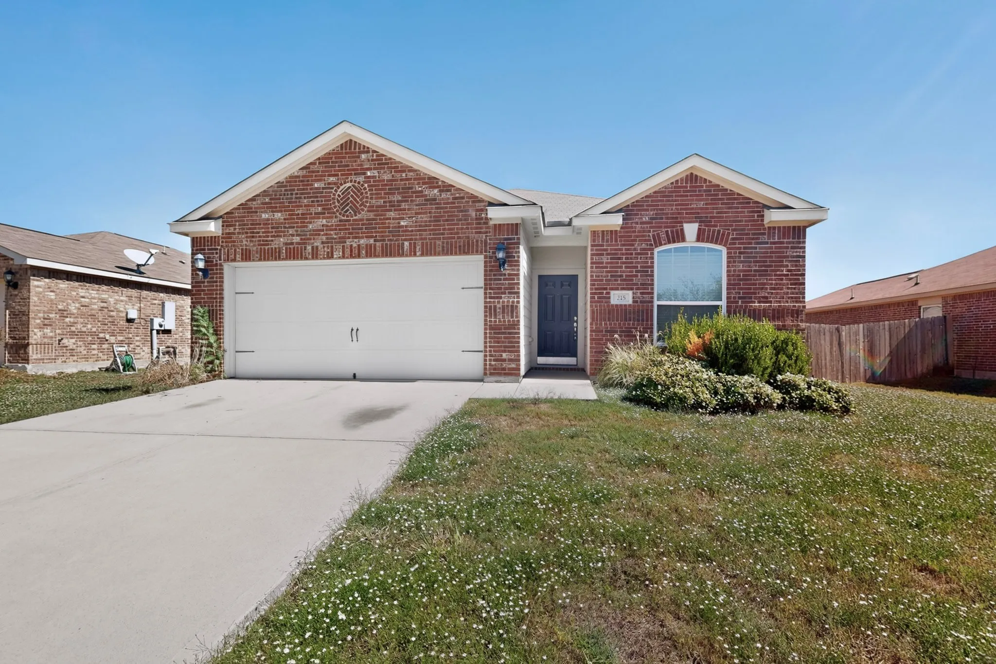 Brick exterior with a gabled roofline, featuring an integrated single-car garage