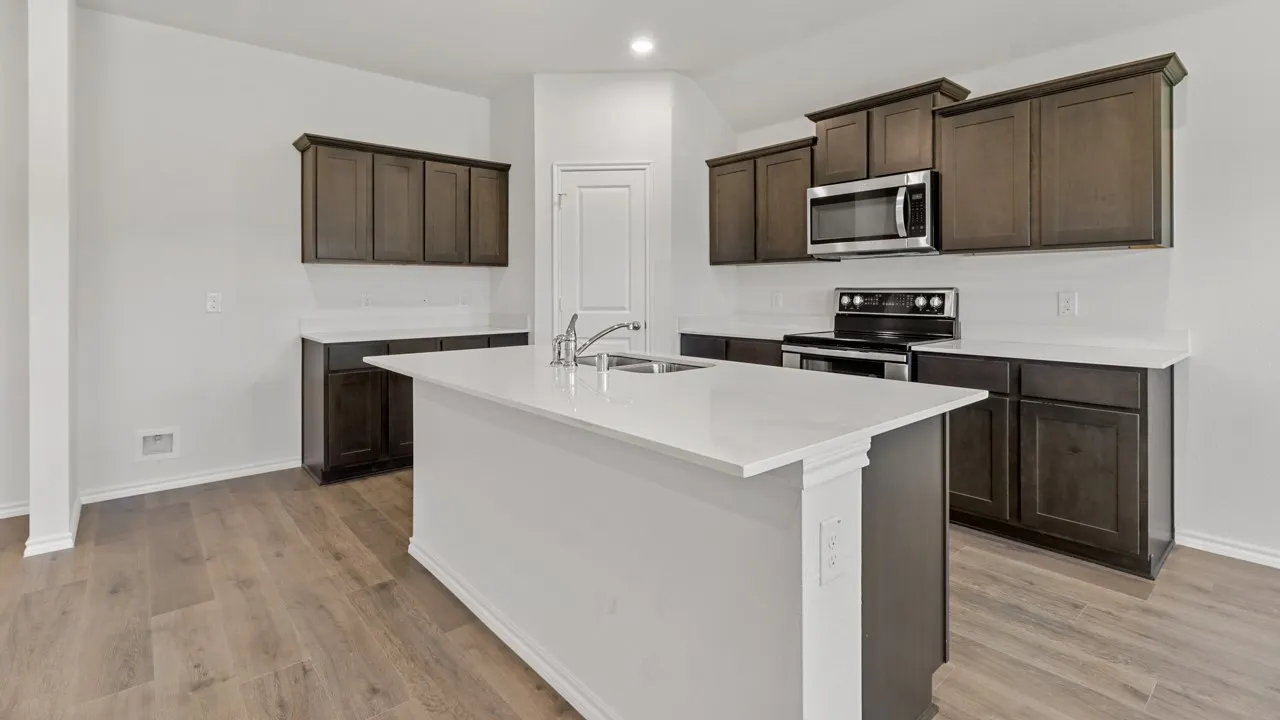 Modern kitchen featuring a central island, wood-finish flooring, dark wood cabinetry, white countertops, and a white tile backsplash