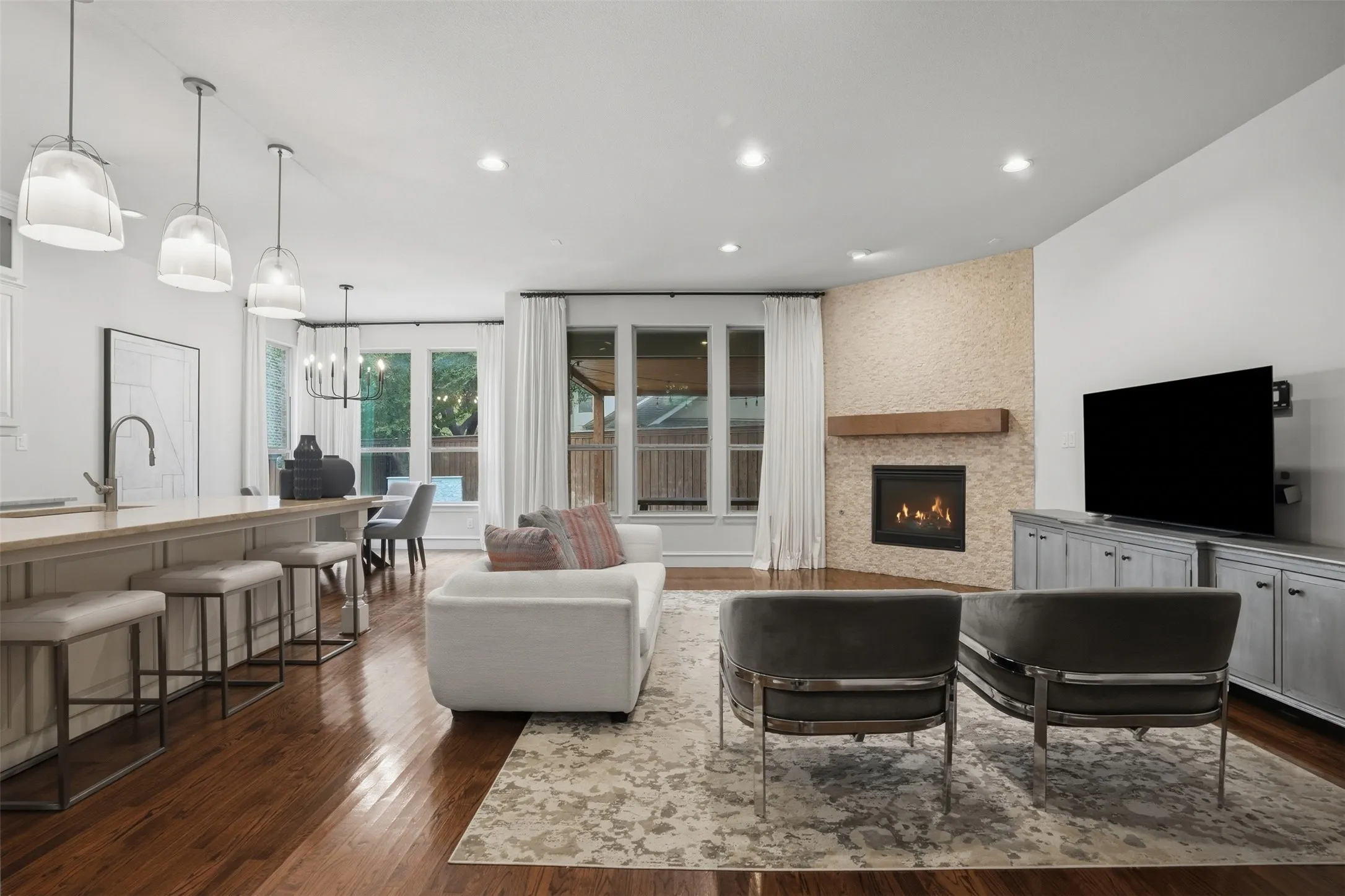 Living room opens to kitchen and overlooks the back patio and pool