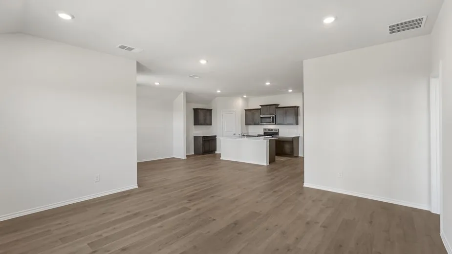 Expansive open-concept living area featuring wood-finish flooring and recessed lighting