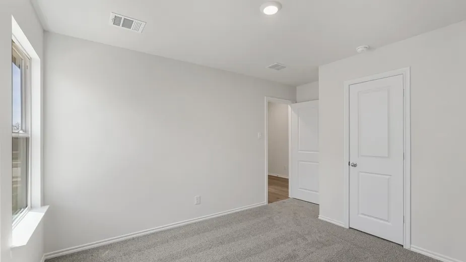 Room featuring light gray carpet flooring, white walls, and a single window with a white frame