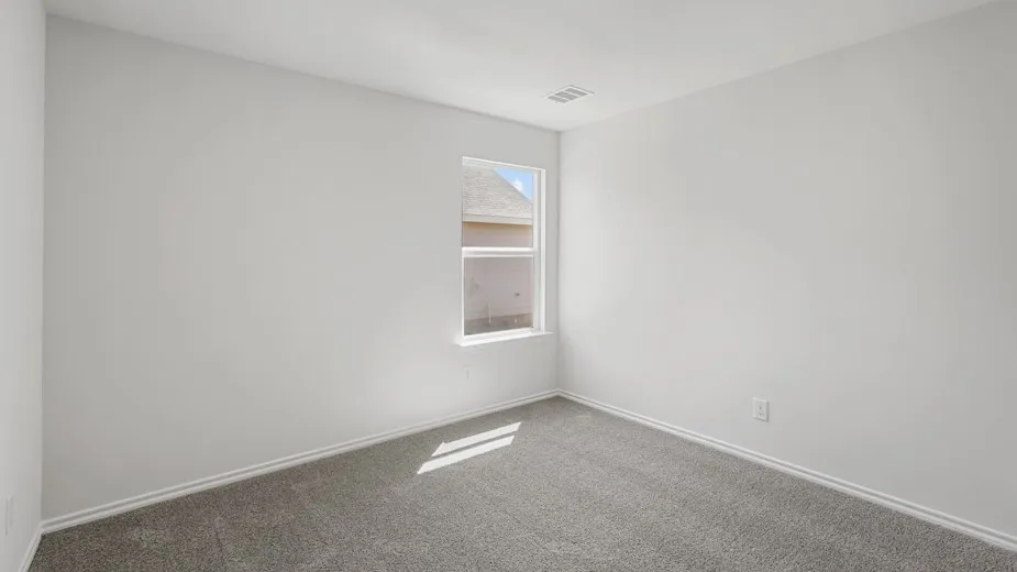 Neutral gray carpeting with white baseboards and walls