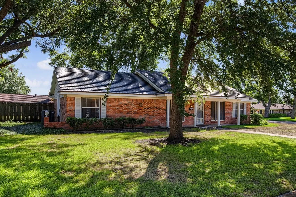 Brick exterior with a gabled roof and covered entry