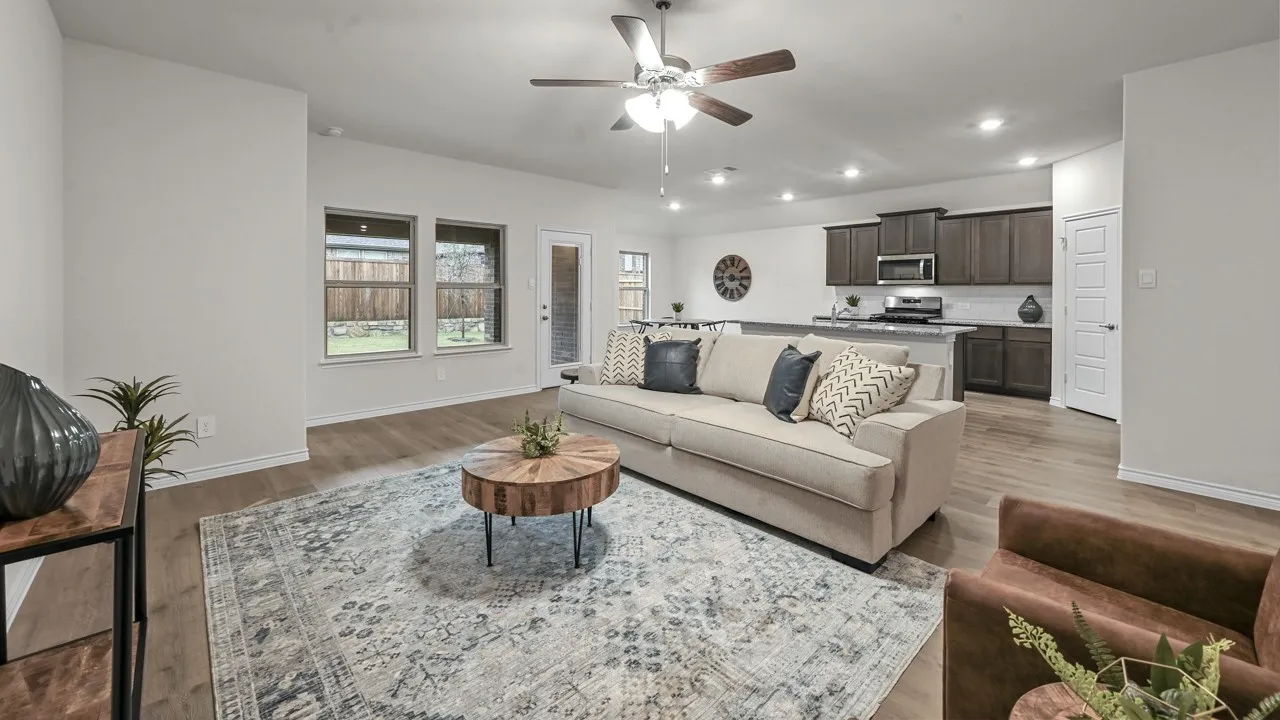 Open-concept living area featuring wood-finish flooring, recessed lighting, and a ceiling fan