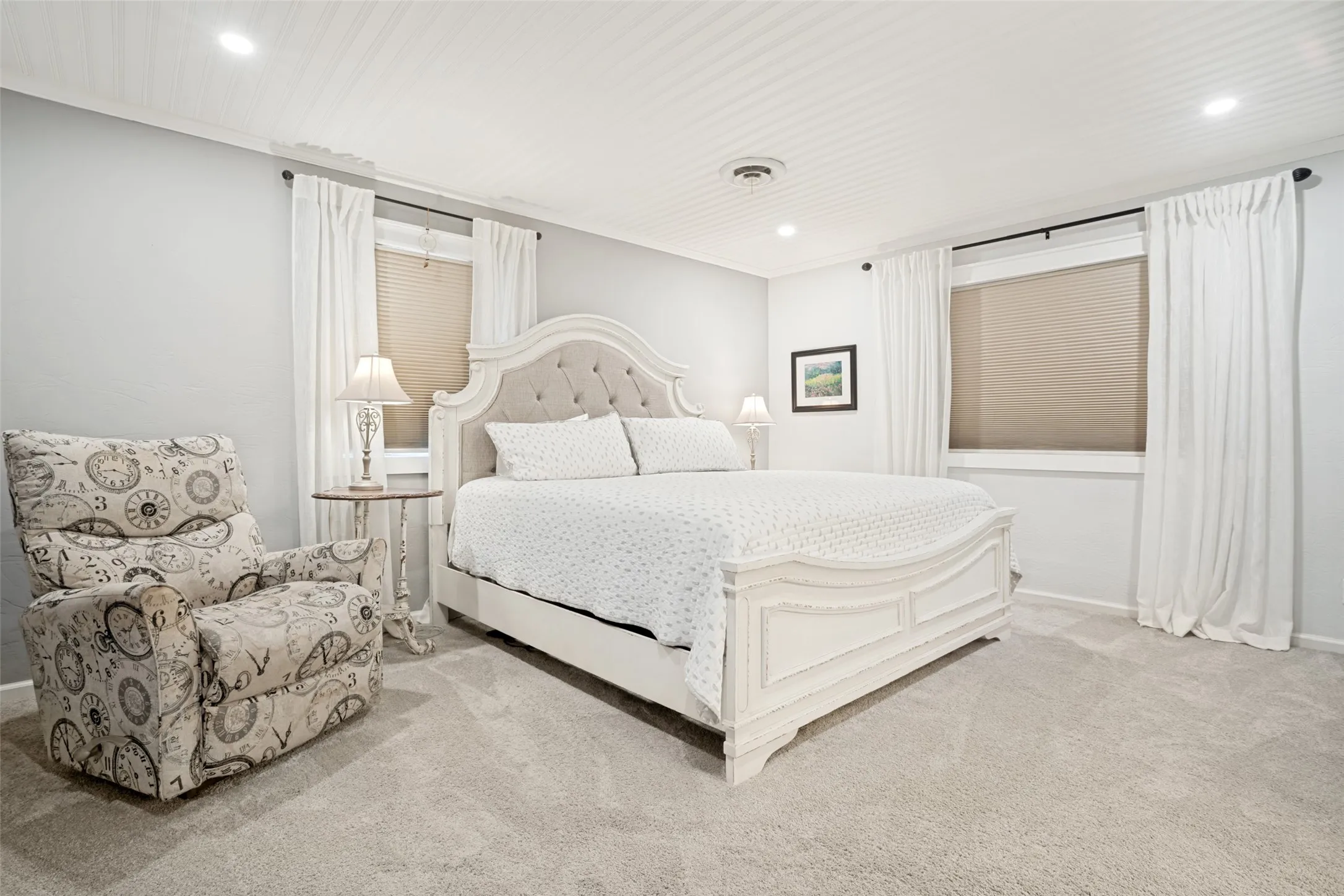 Recessed lighting, light-toned carpeting, and a beadboard ceiling