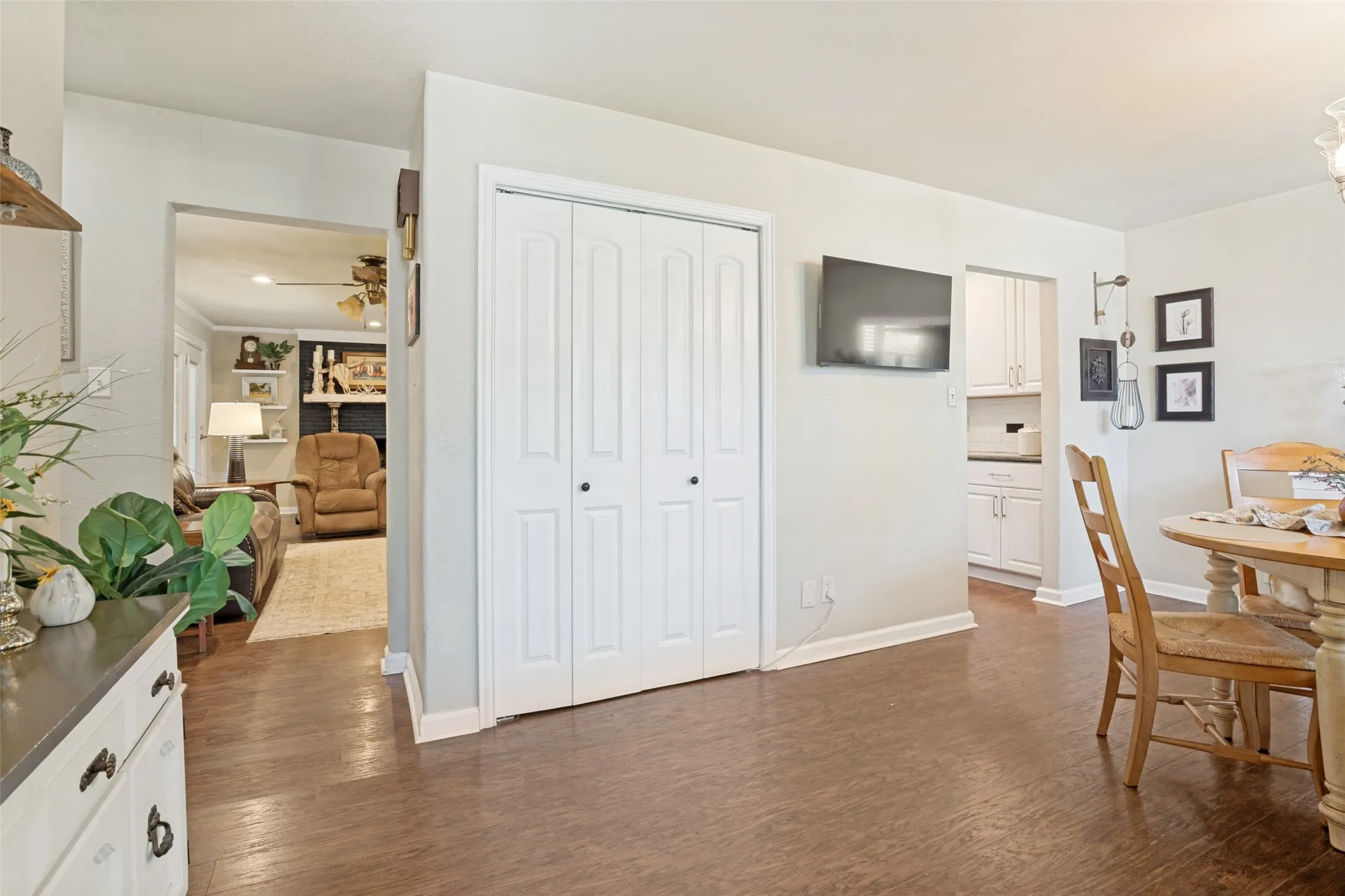 Wood-like flooring throughout, white bi-fold closet doors, and white painted walls