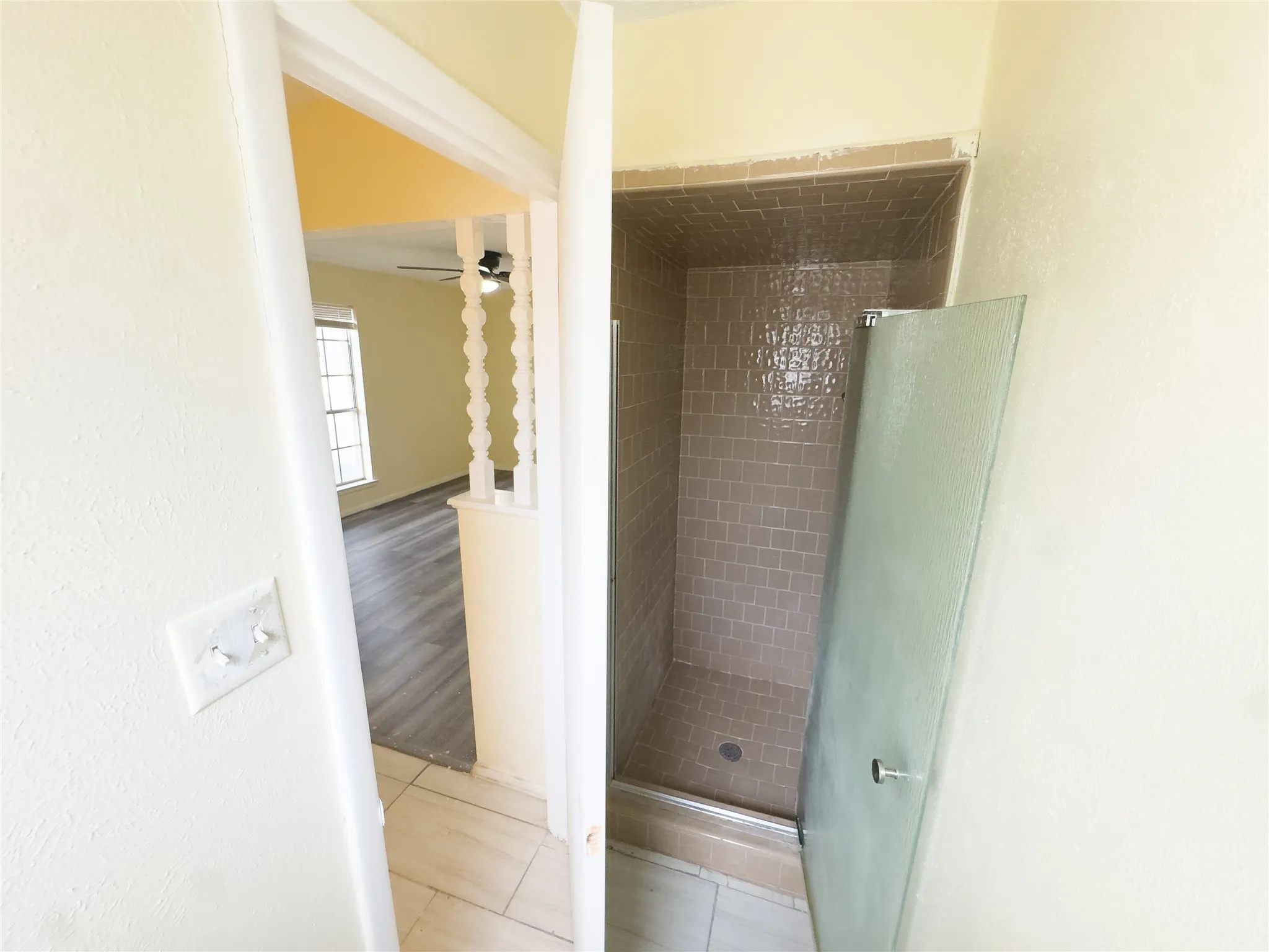 Shower with tiled walls and glass door