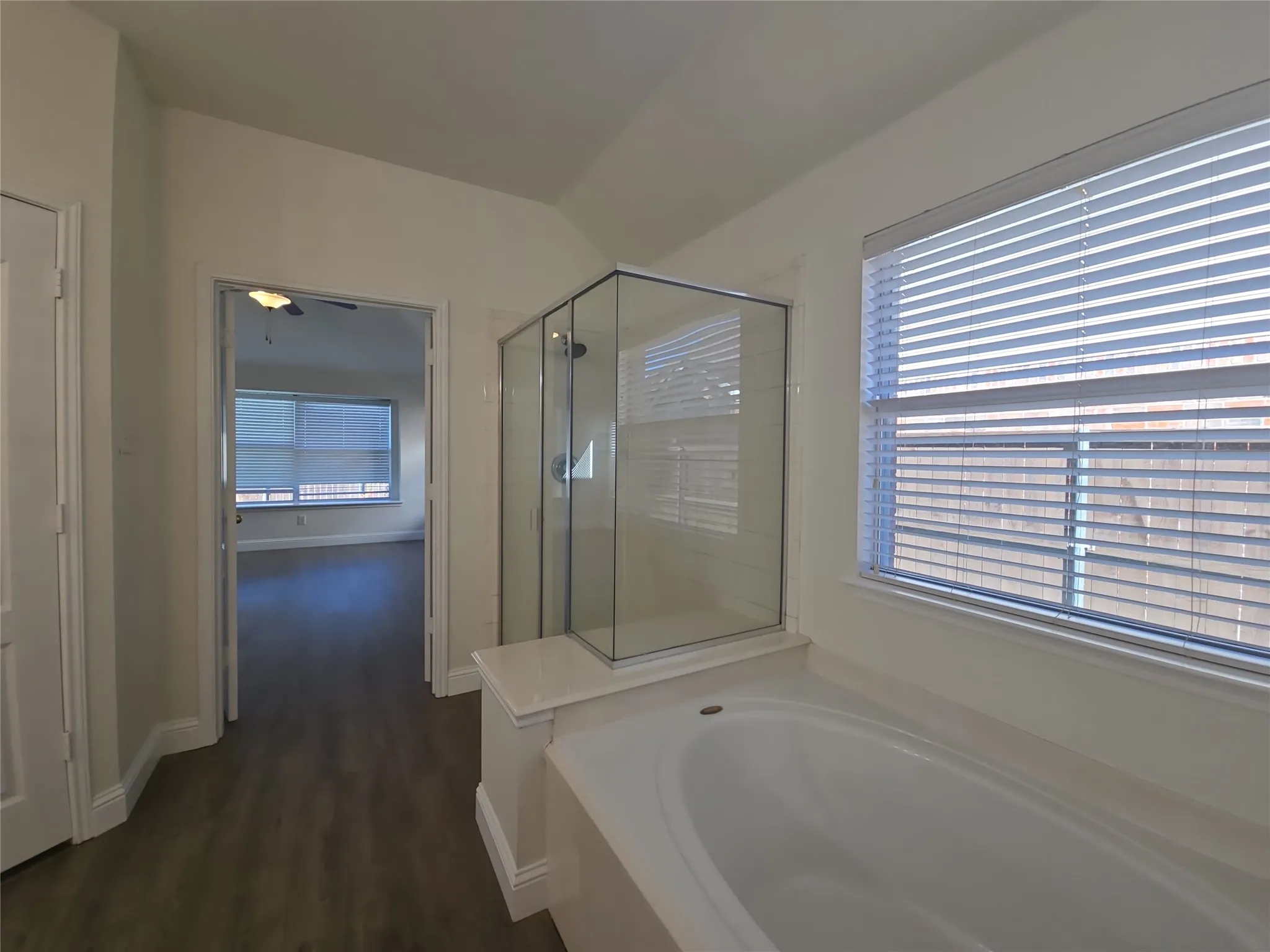 Walk-in shower with clear glass enclosure and tile surround