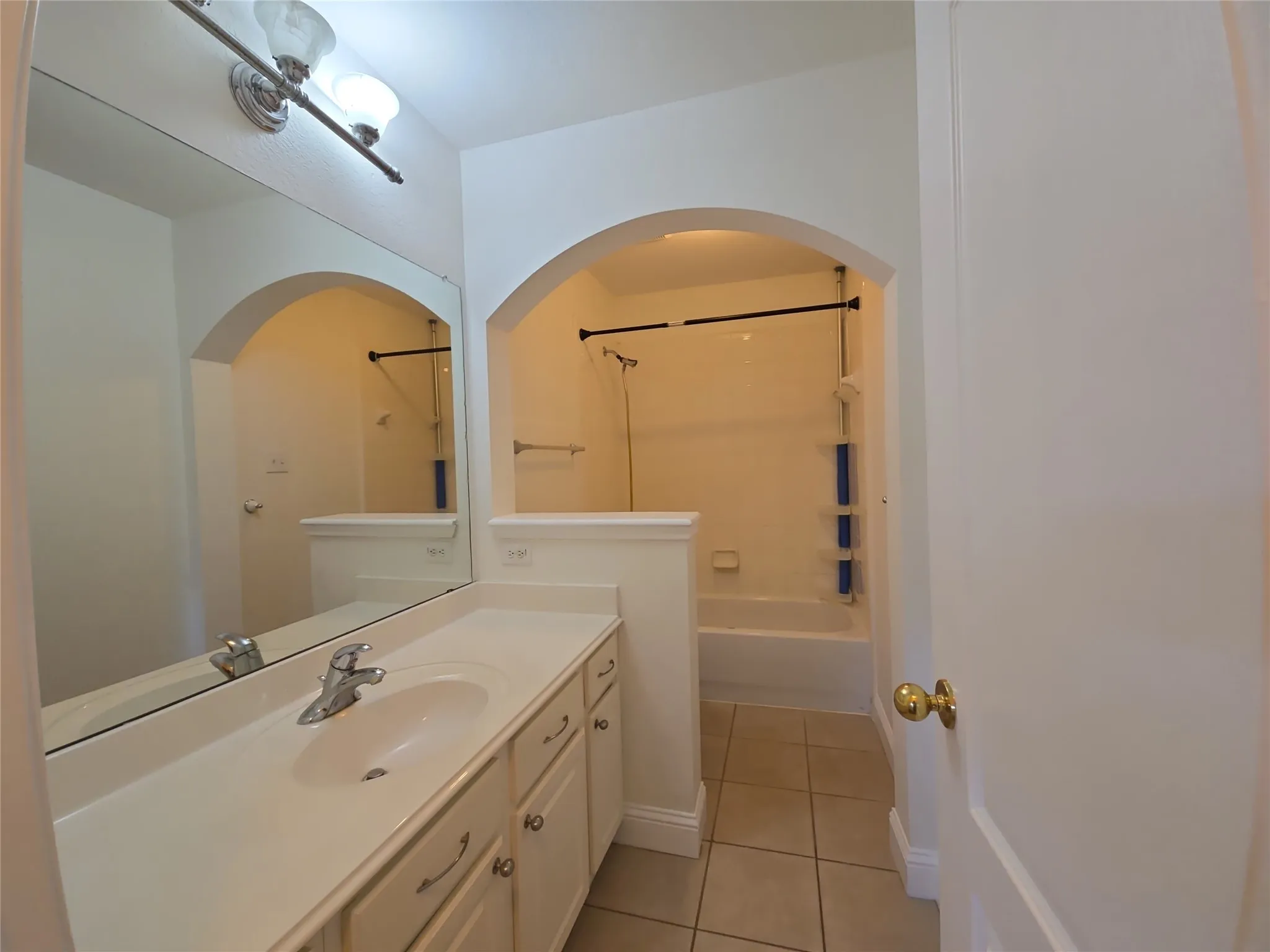 Double vanity with integrated sink, chrome faucet, and under-cabinet storage