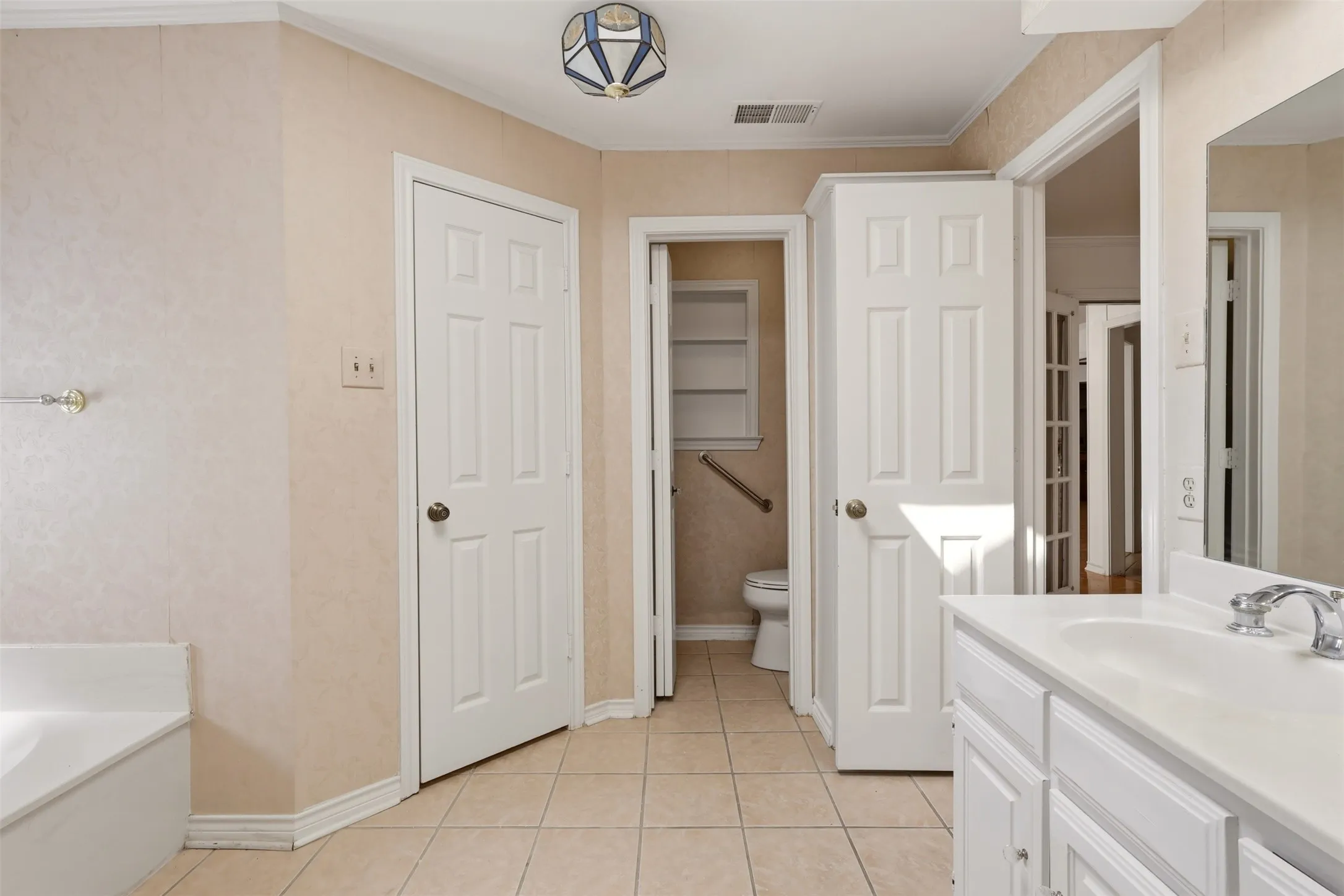 Double vanity featuring white cabinetry and an integrated sink