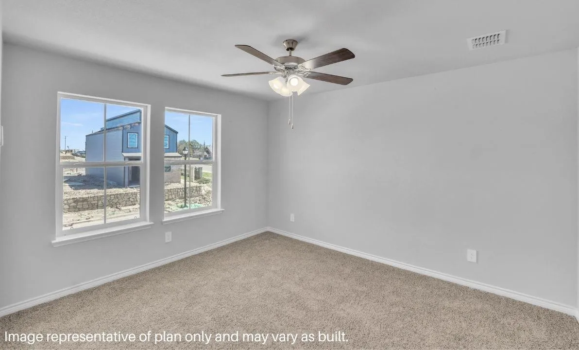 Two large windows, carpeted flooring, and a ceiling fan with integrated lighting