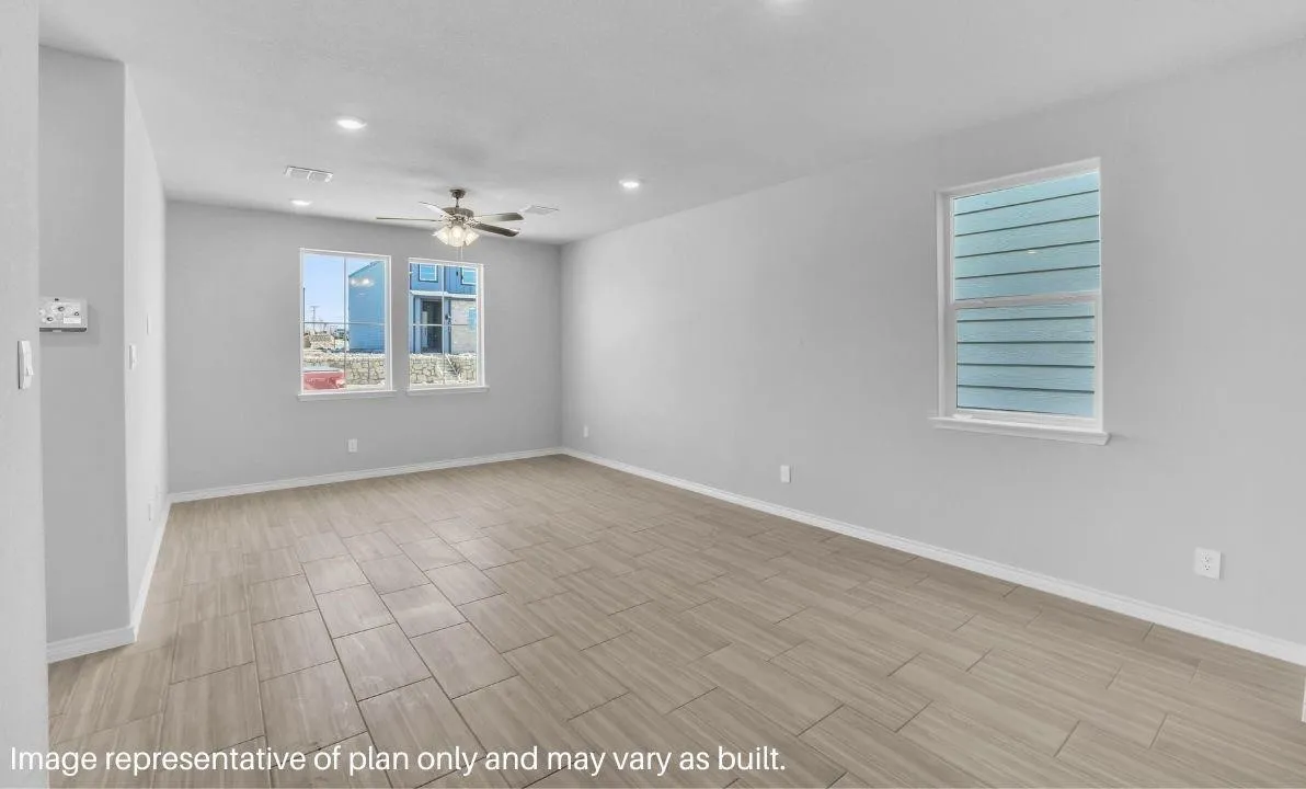 Spacious room featuring tile flooring, multiple windows, a ceiling fan, and recessed lighting
