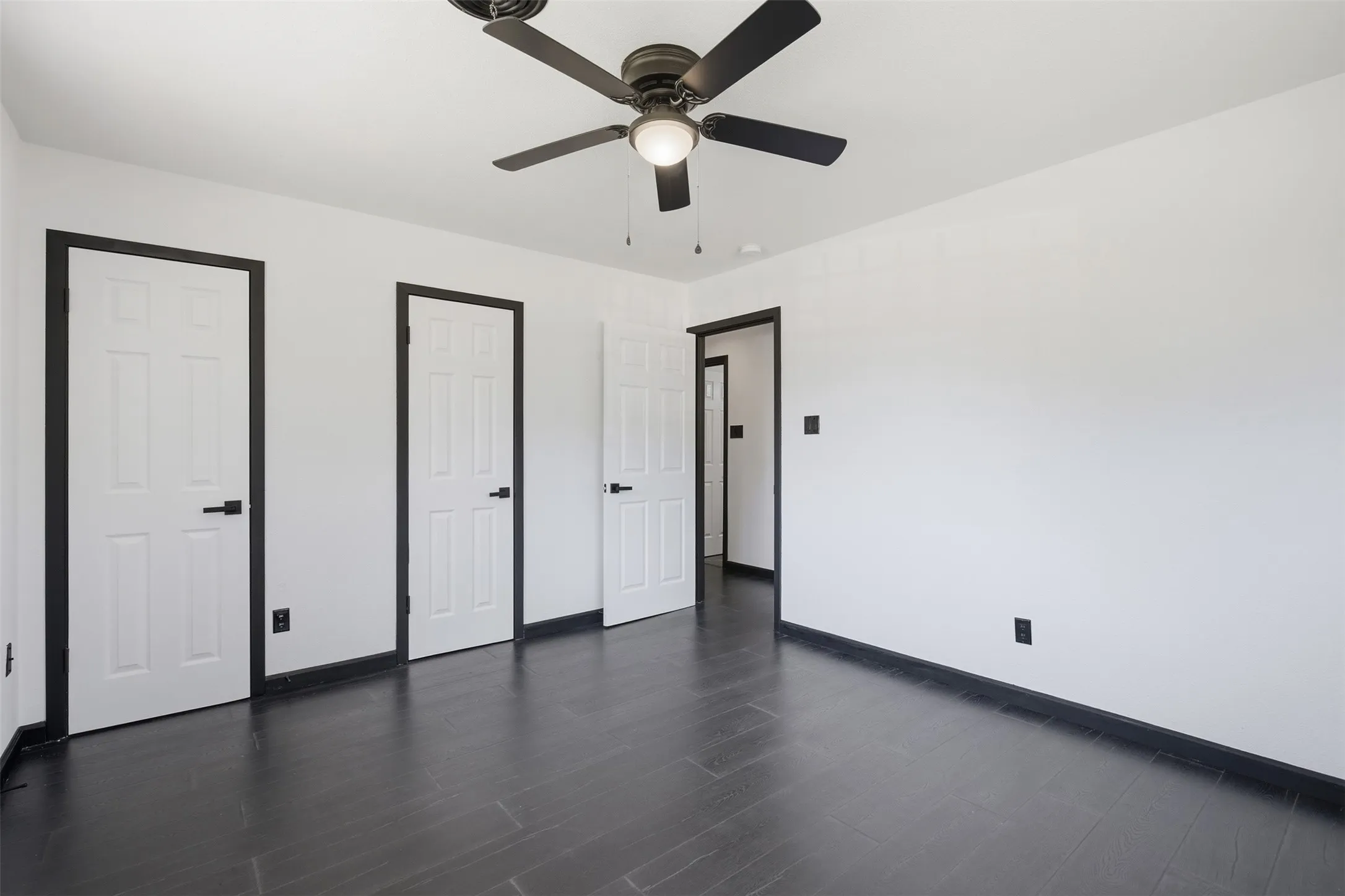 Dark wood-finish flooring with coordinating baseboards