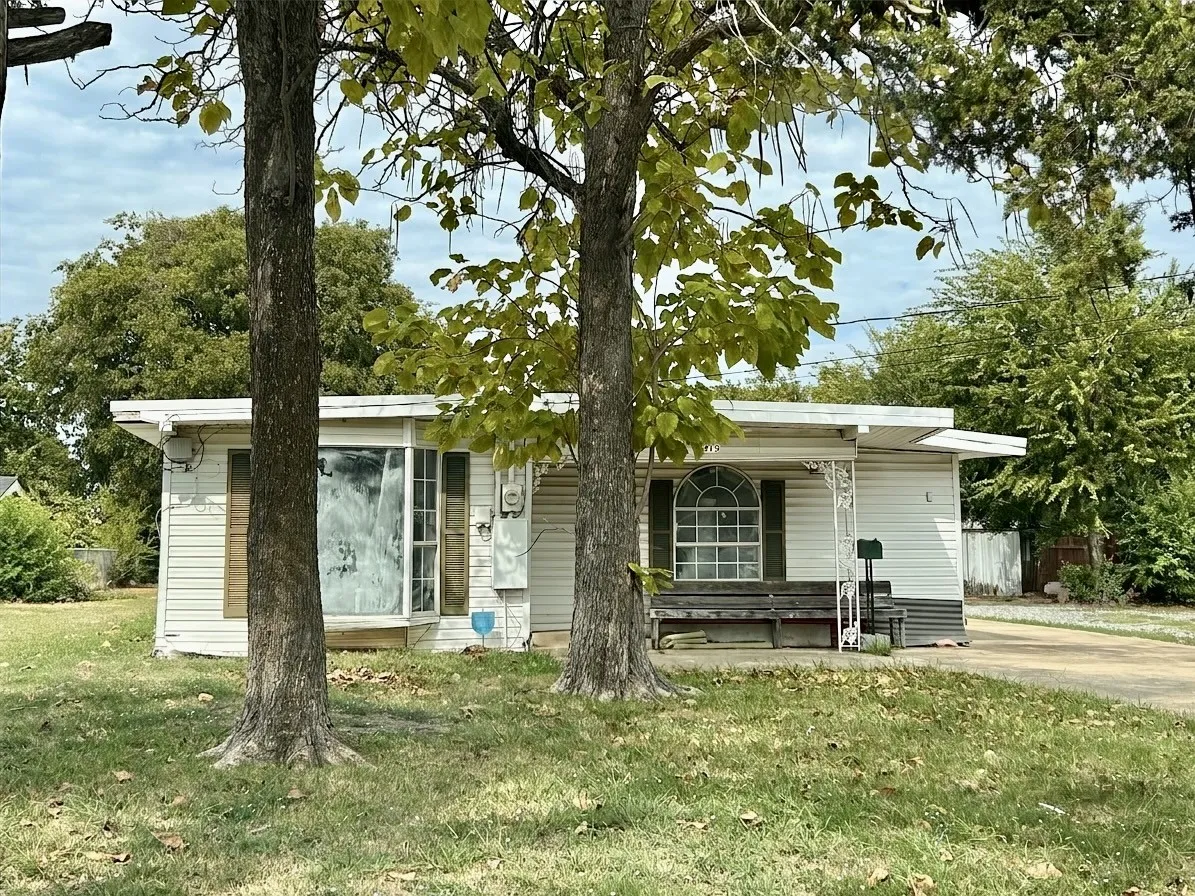 White siding exterior with a flat roofline