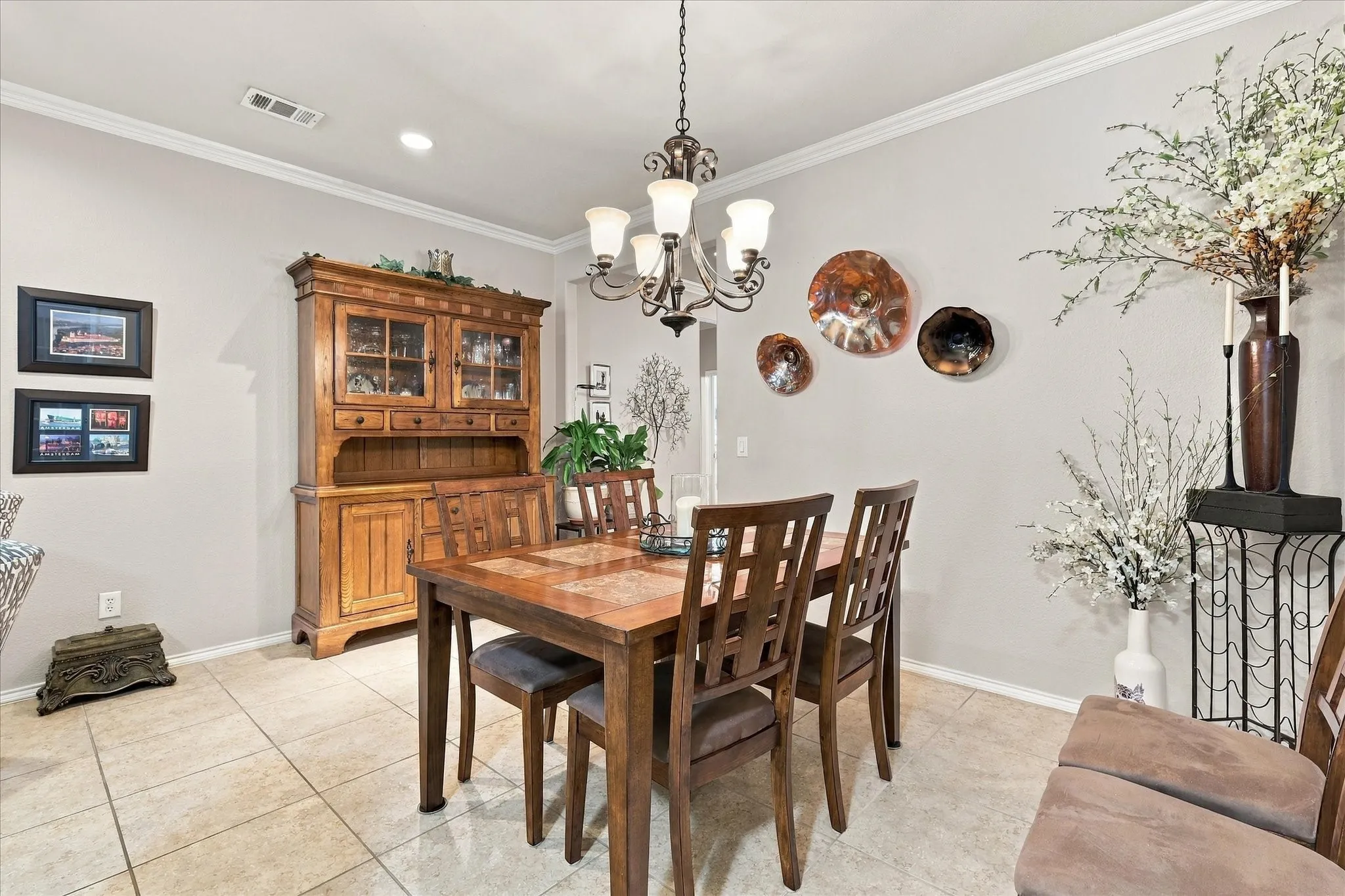 Dining area featuring tile flooring, crown molding, a multi-light chandelier, and recessed lighting