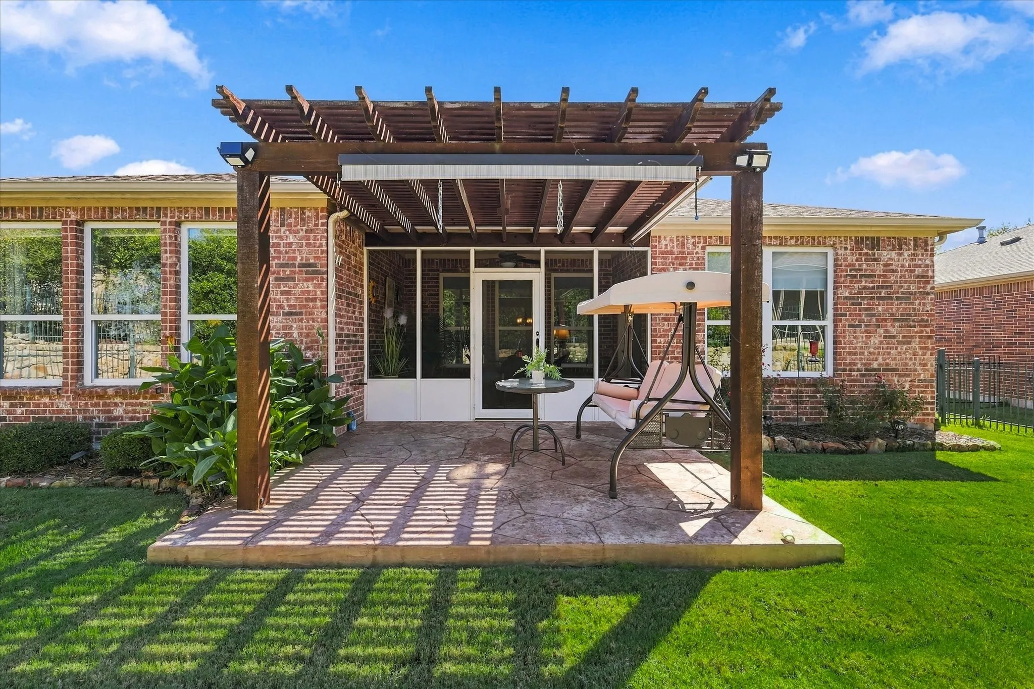 Wood pergola with a stamped concrete patio