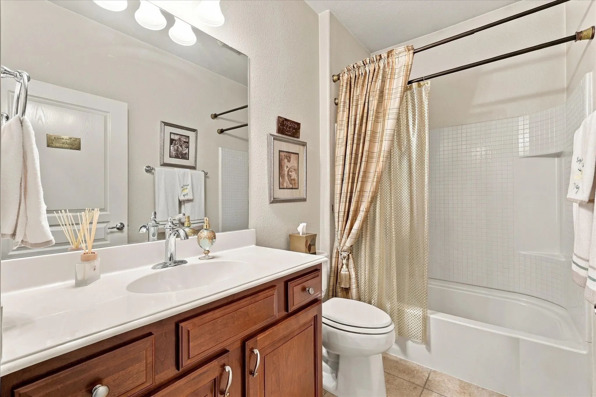 Single vanity with a white countertop, chrome faucet, and wood-finish cabinetry
