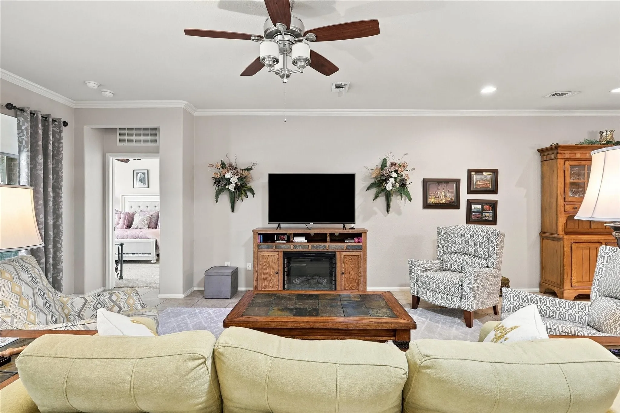 Recessed lighting, crown molding, and a ceiling fan with light fixture