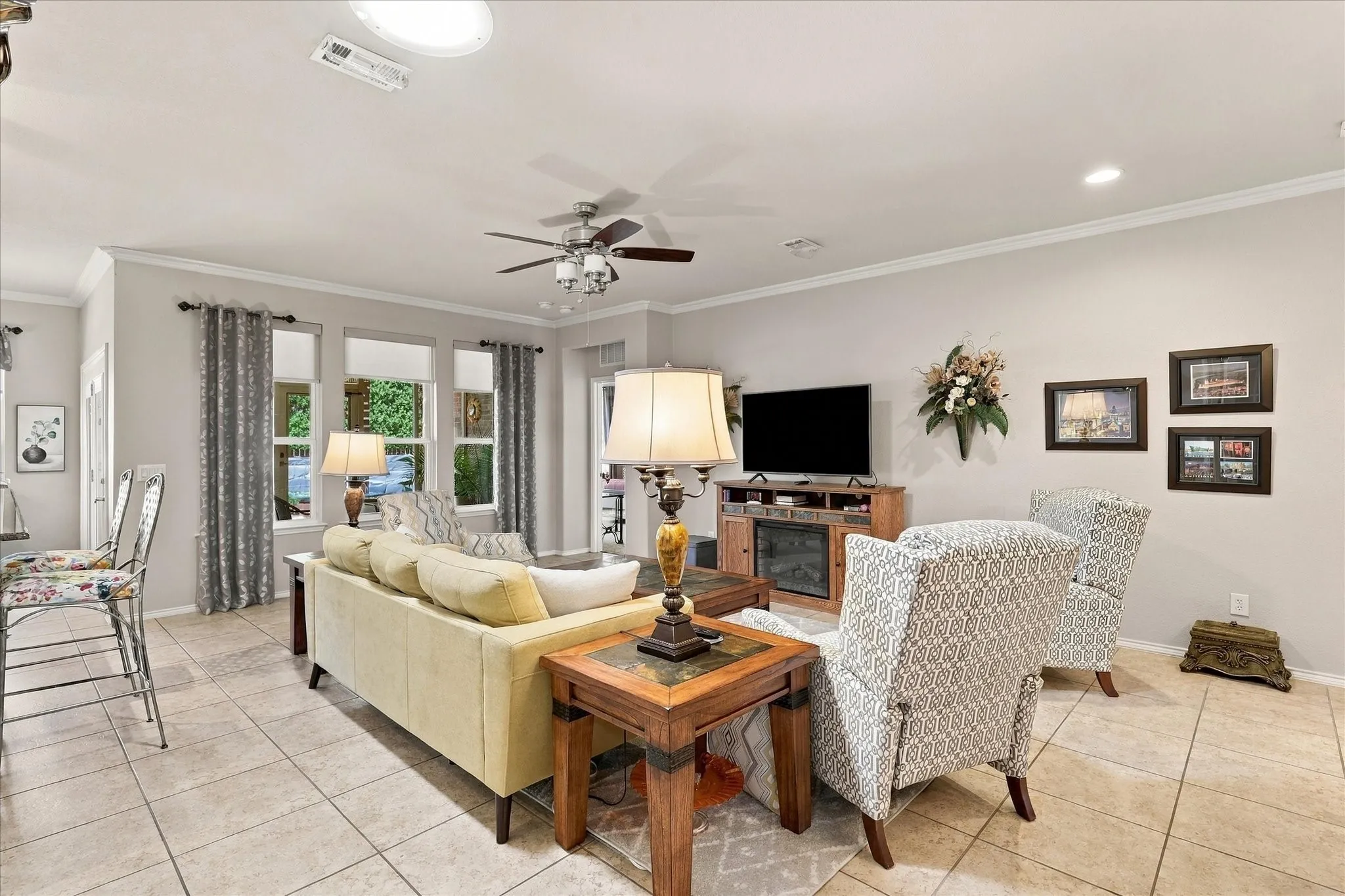 Tiled flooring throughout living areas, crown molding and multiple windows