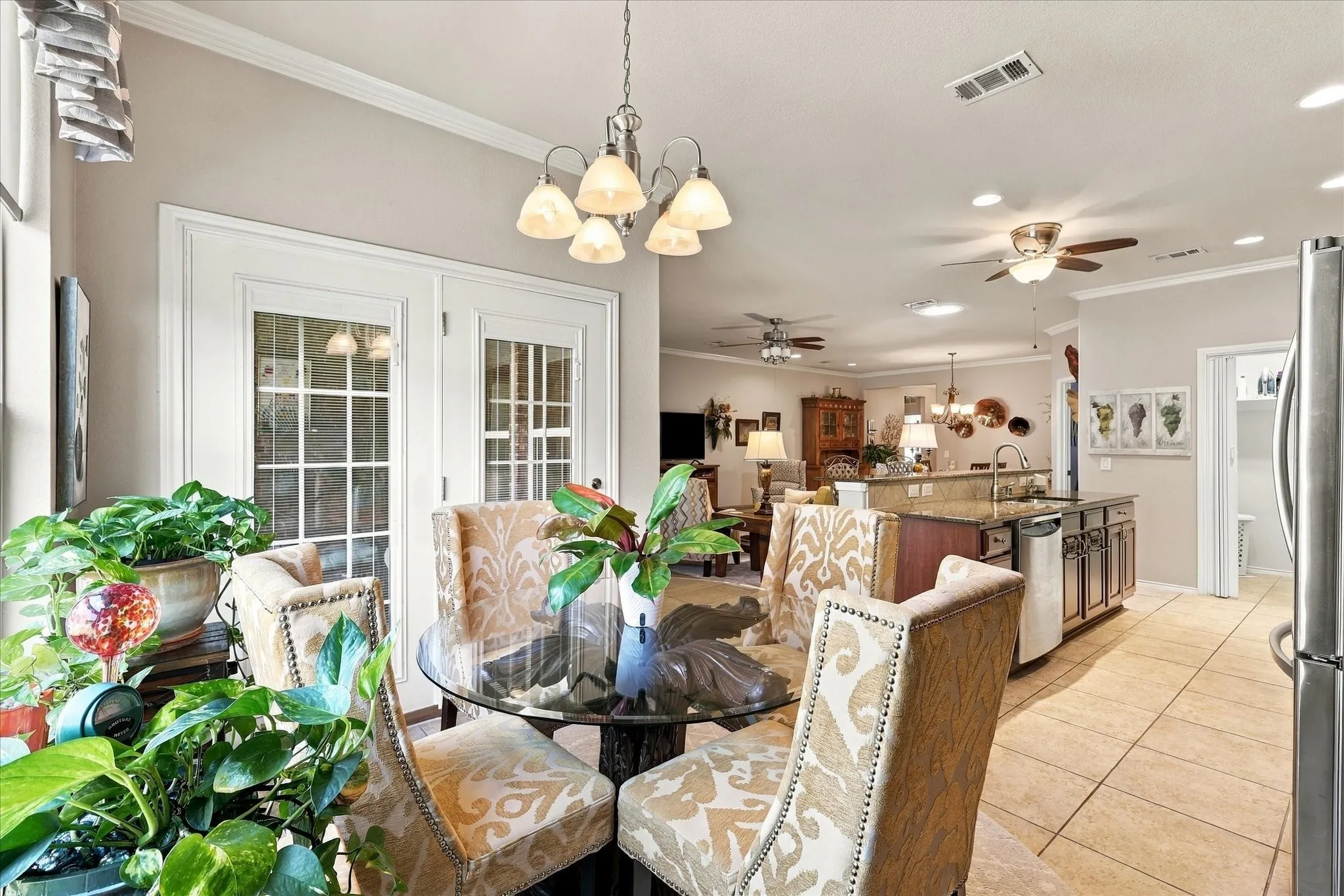 French doors with divided lites, recessed lighting, crown molding, tile flooring, and a ceiling fan