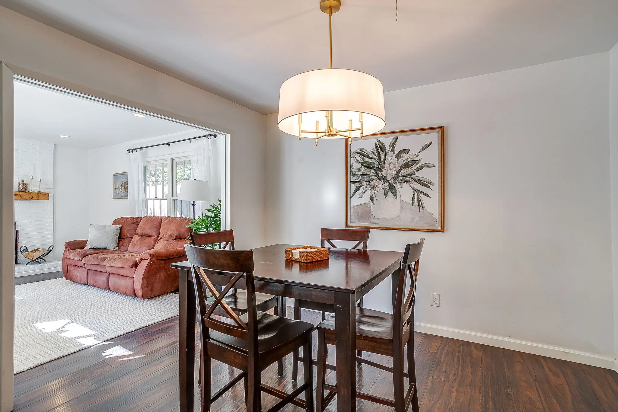 Hardwood-finish flooring, recessed lighting, and a modern drum pendant light