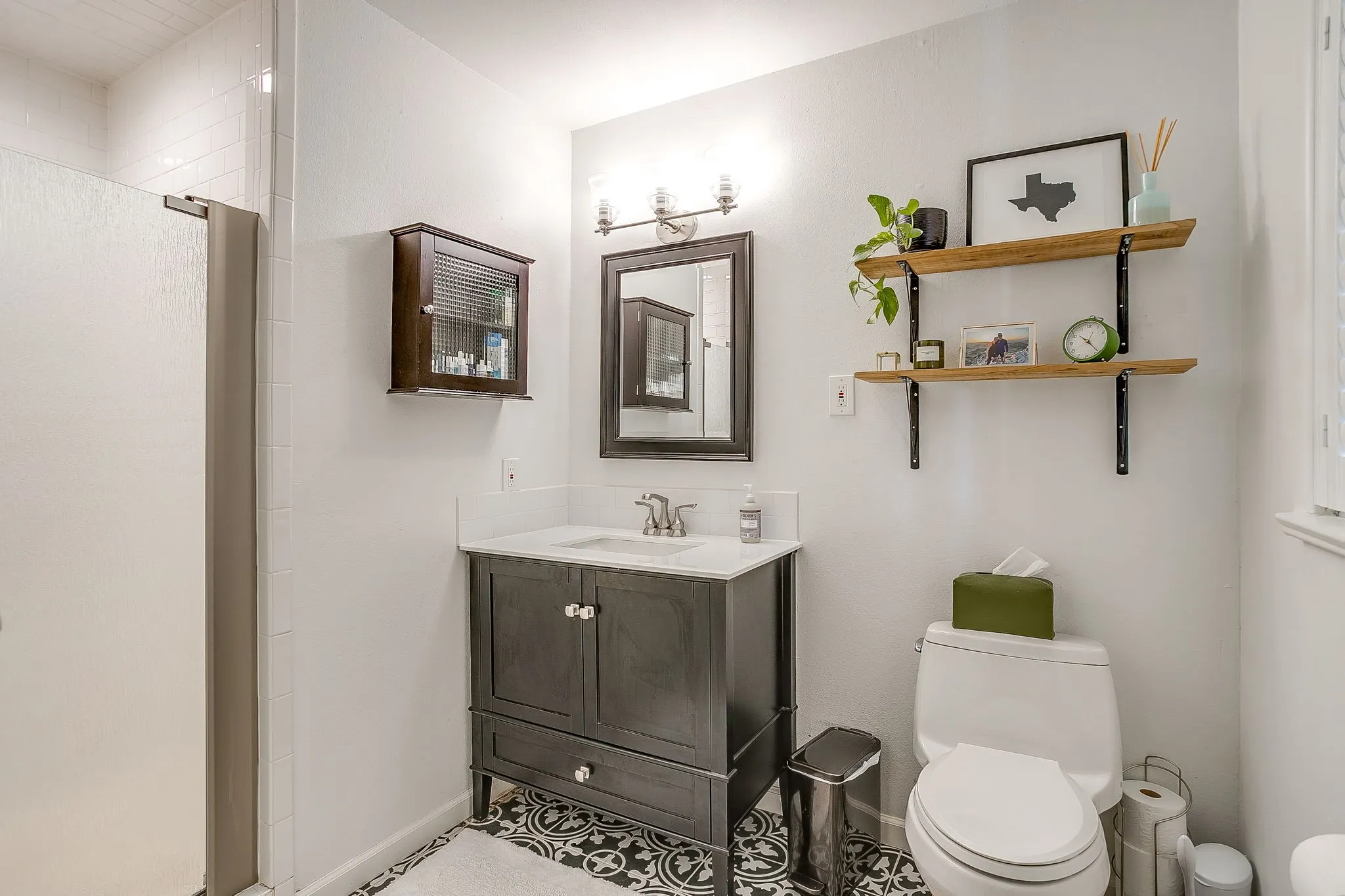 White subway tile shower surround with glass enclosure