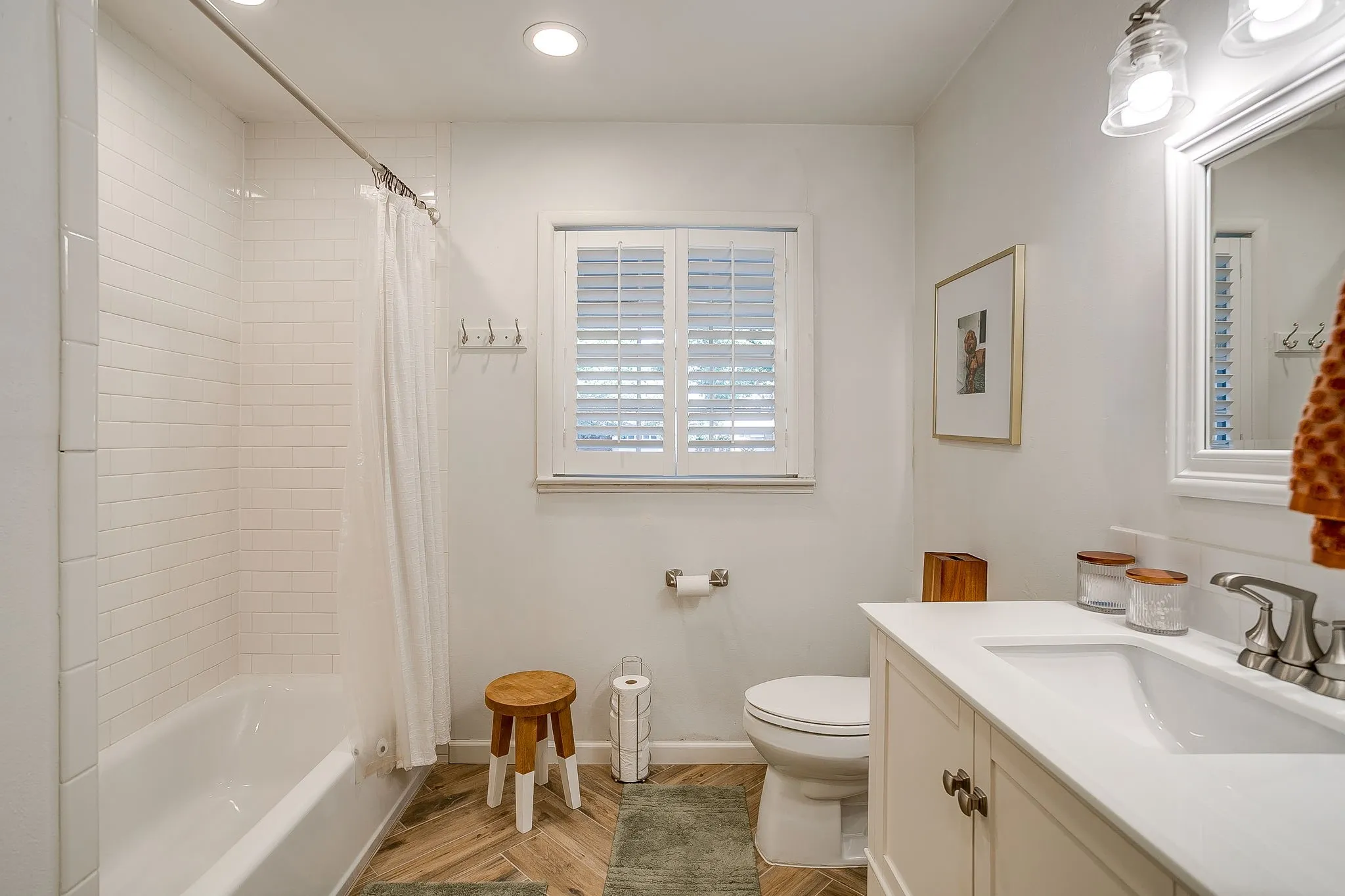 Full bathroom with white subway tile shower surround and a single vanity with an integrated sink