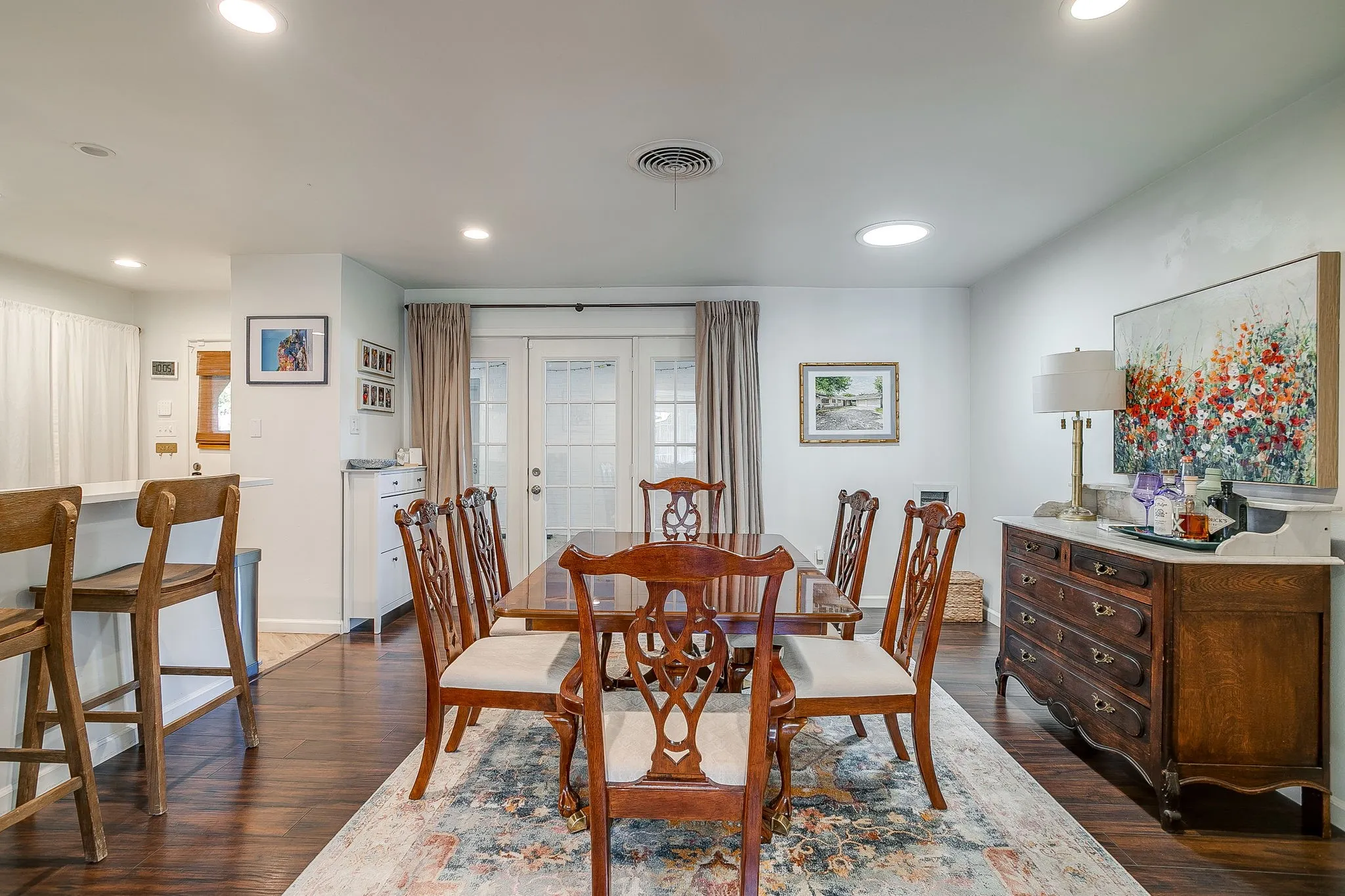 Recessed ceiling lighting, wood-finish flooring, white walls, and French doors