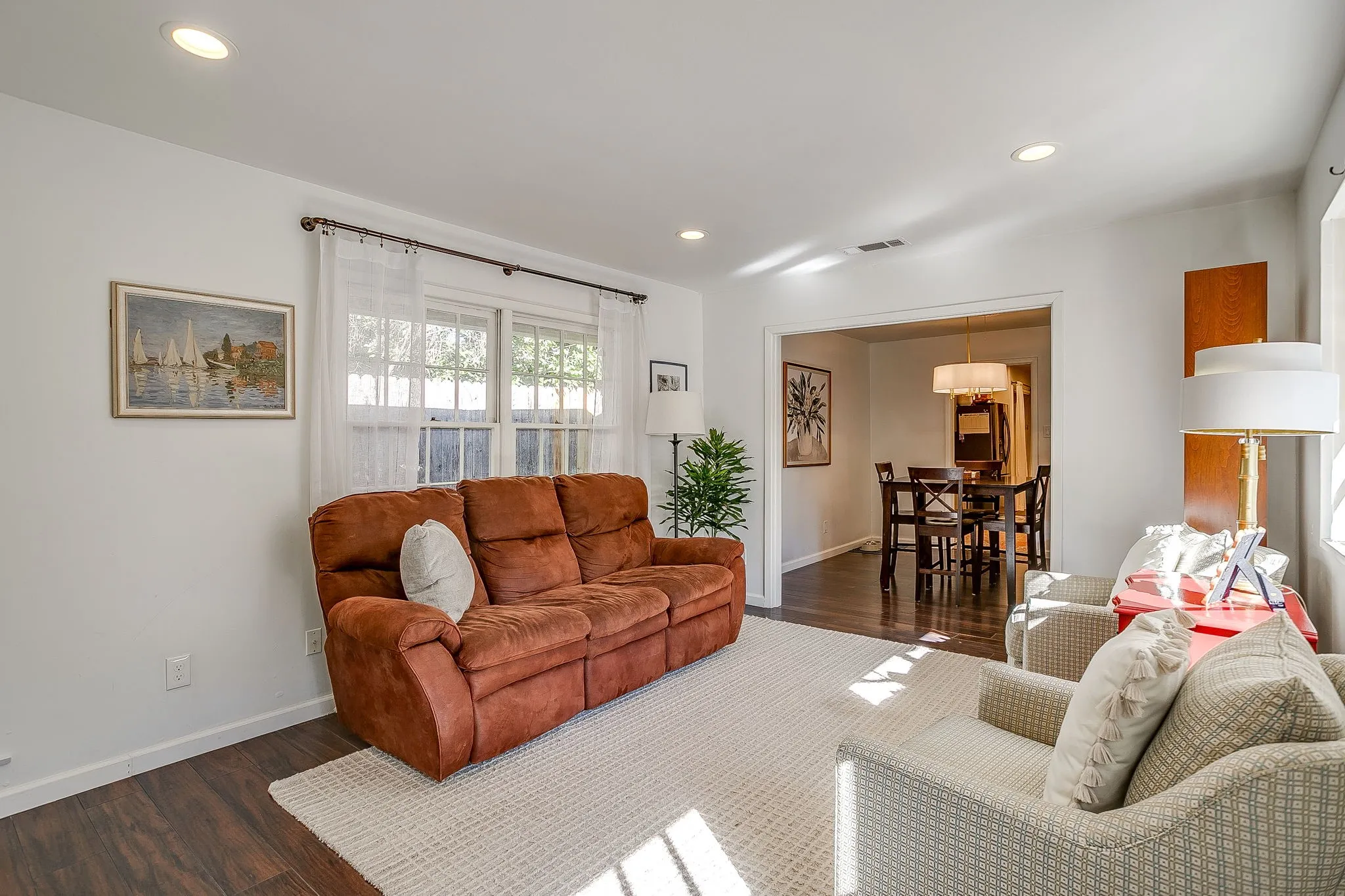 Recessed ceiling lighting, wood-finish flooring, and white walls