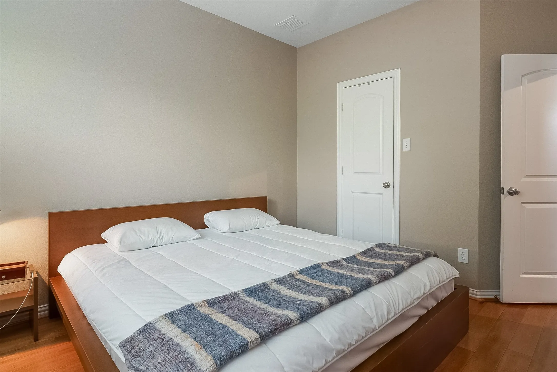 Warm neutral-toned walls complement wood-finish flooring